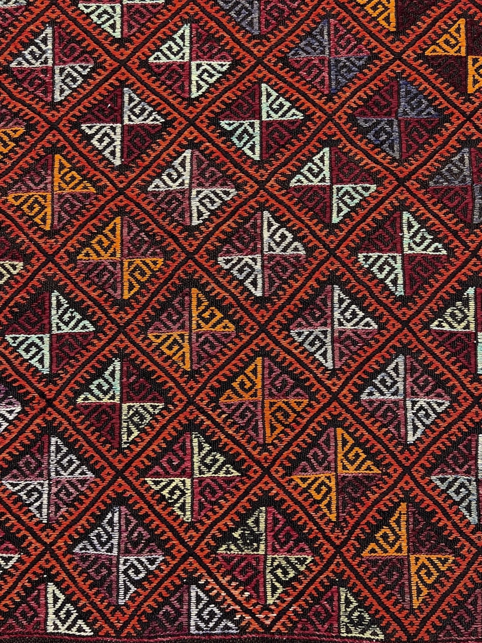 Patterned fabric with geometric design on a red background