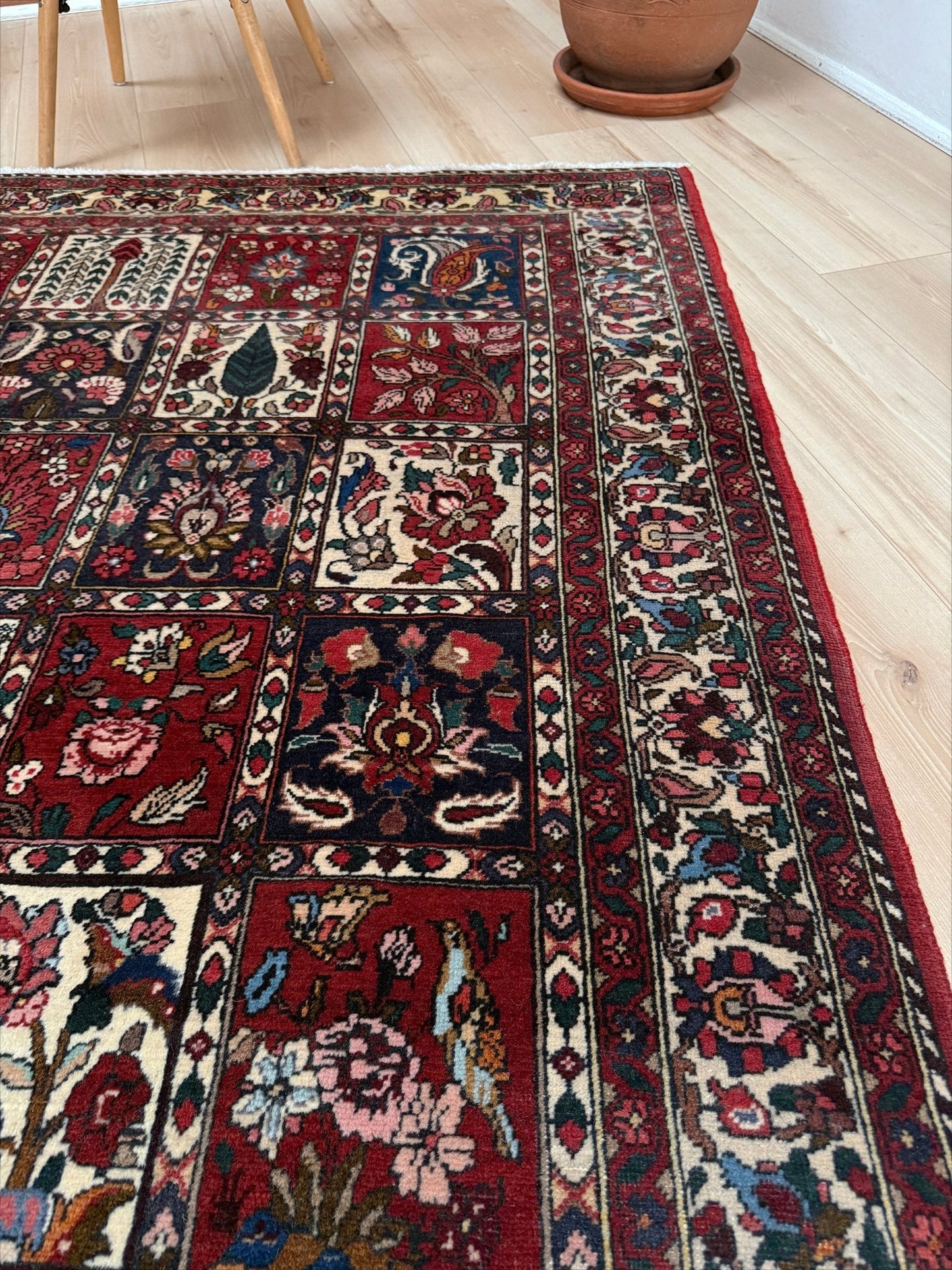 Vintage Persian Bakhtiari rug wit red field, navy garden panels, ivory details, and intricate floral motifs, handmade wool area rug 5x8 from Indigo Rugs Burlingame SF Bay Area