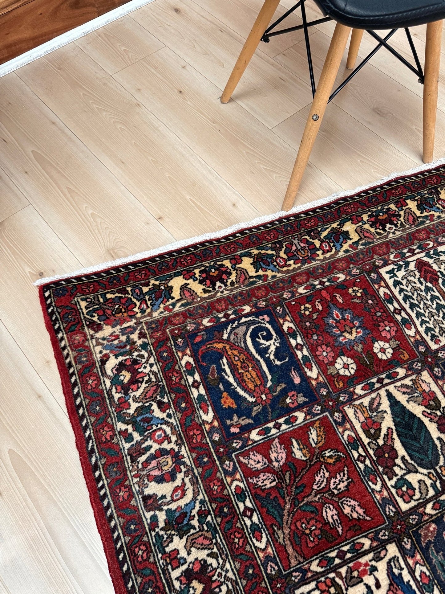 Vintage Persian Bakhtiari rug wit red field, navy garden panels, ivory details, and intricate floral motifs, handmade wool area rug 5x8 from Indigo Rugs Burlingame SF Bay Area