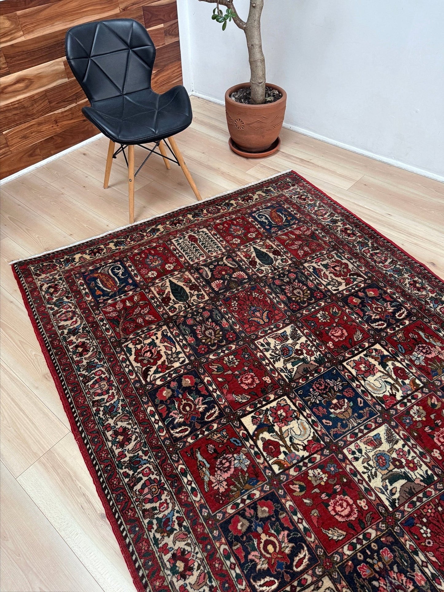 Vintage Persian Bakhtiari rug wit red field, navy garden panels, ivory details, and intricate floral motifs, handmade wool area rug 5x8 from Indigo Rugs Burlingame SF Bay Area