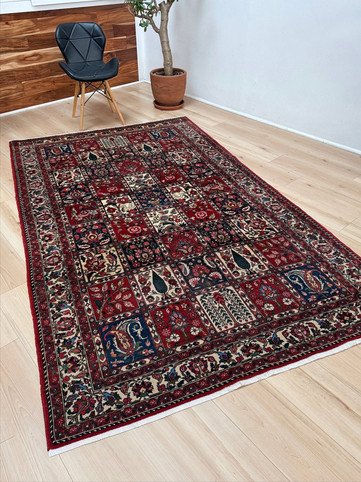 Vintage Persian Bakhtiari rug wit red field, navy garden panels, ivory details, and intricate floral motifs, handmade wool area rug 5x8 from Indigo Rugs Burlingame SF Bay Area