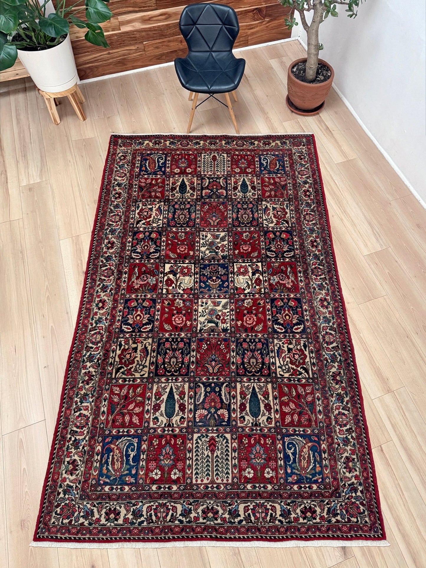 Vintage Persian Bakhtiari rug wit red field, navy garden panels, ivory details, and intricate floral motifs, handmade wool area rug 5x8 from Indigo Rugs Burlingame SF Bay Area