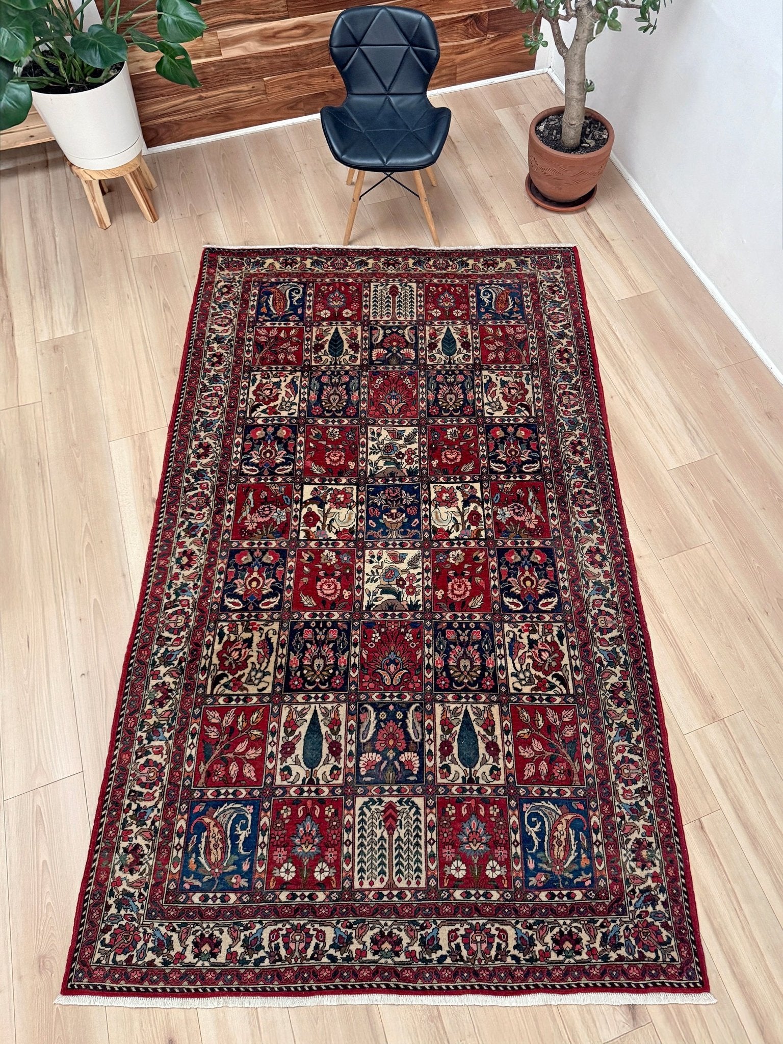 Vintage Persian Bakhtiari rug wit red field, navy garden panels, ivory details, and intricate floral motifs, handmade wool area rug 5x8 from Indigo Rugs Burlingame SF Bay Area