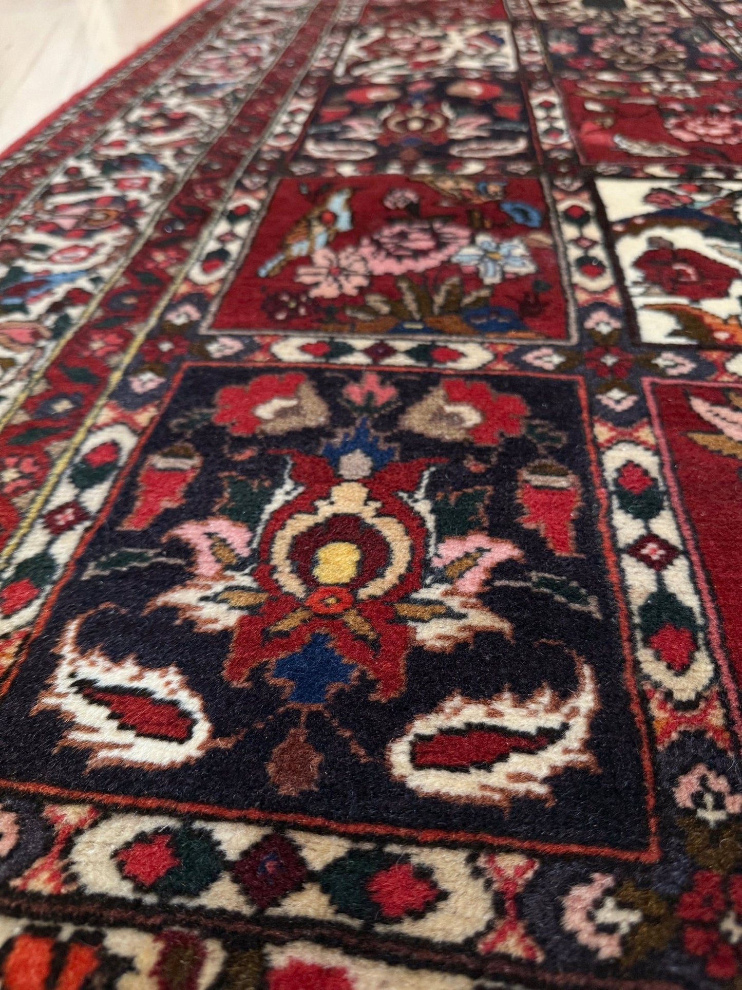 Vintage Persian Bakhtiari rug wit red field, navy garden panels, ivory details, and intricate floral motifs, handmade wool area rug 5x8 from Indigo Rugs Burlingame SF Bay Area