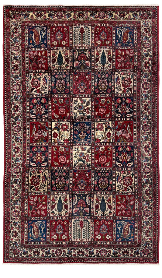 Vintage Persian Bakhtiari rug wit red field, navy garden panels, ivory details, and intricate floral motifs, handmade wool area rug 5x8 from Indigo Rugs Burlingame SF Bay Area
