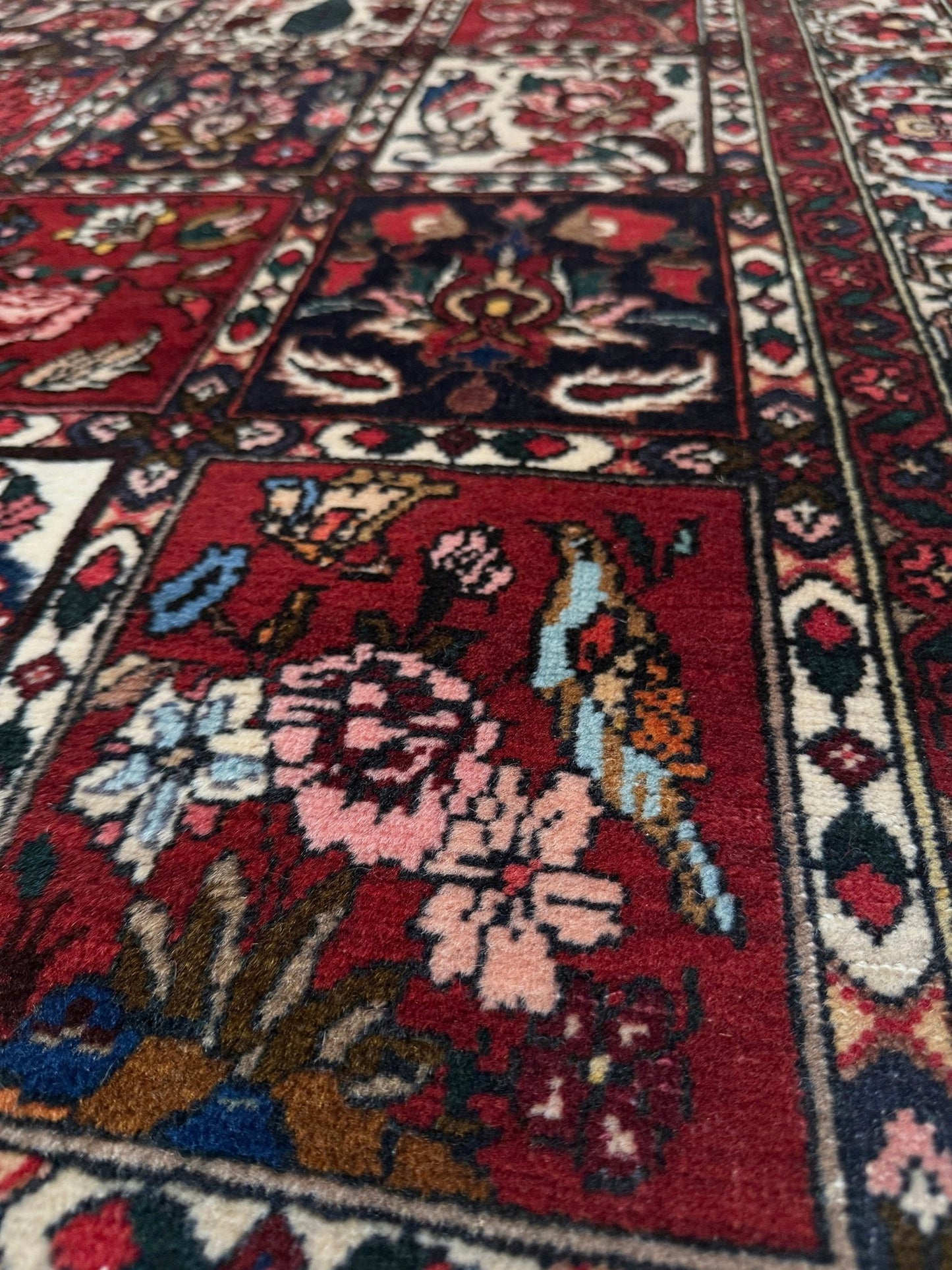 Vintage Persian Bakhtiari rug wit red field, navy garden panels, ivory details, and intricate floral motifs, handmade wool area rug 5x8 from Indigo Rugs Burlingame SF Bay Area
