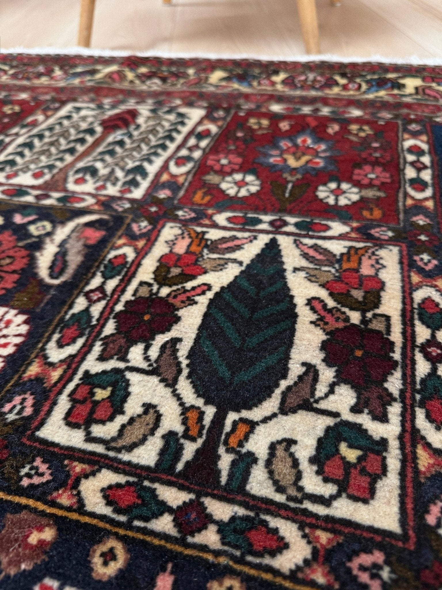 Vintage Persian Bakhtiari rug wit red field, navy garden panels, ivory details, and intricate floral motifs, handmade wool area rug 5x8 from Indigo Rugs Burlingame SF Bay Area