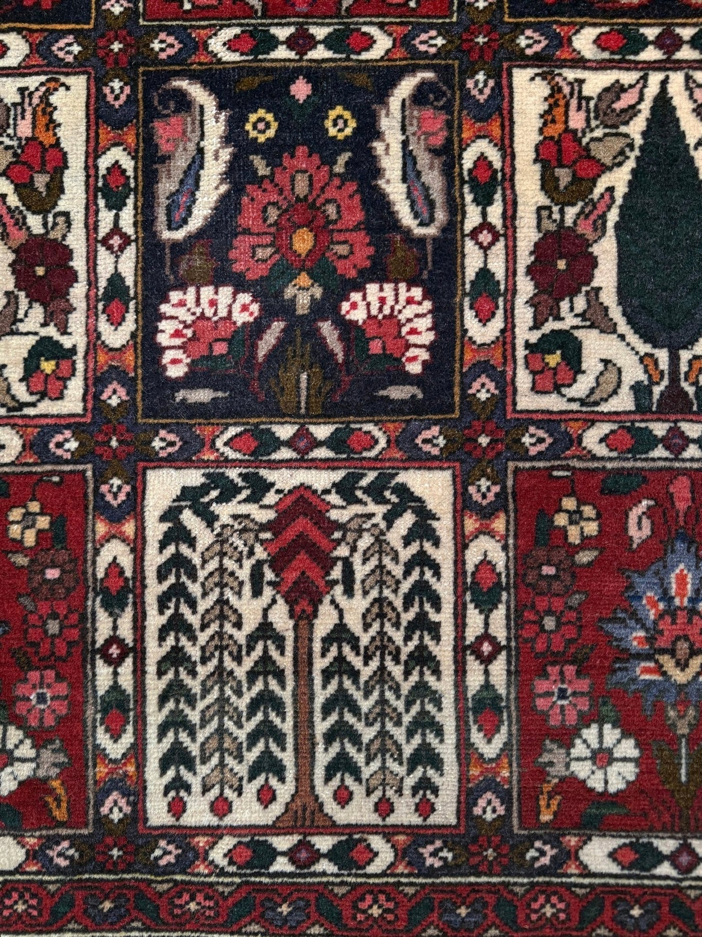 Vintage Persian Bakhtiari rug wit red field, navy garden panels, ivory details, and intricate floral motifs, handmade wool area rug 5x8 from Indigo Rugs Burlingame SF Bay Area