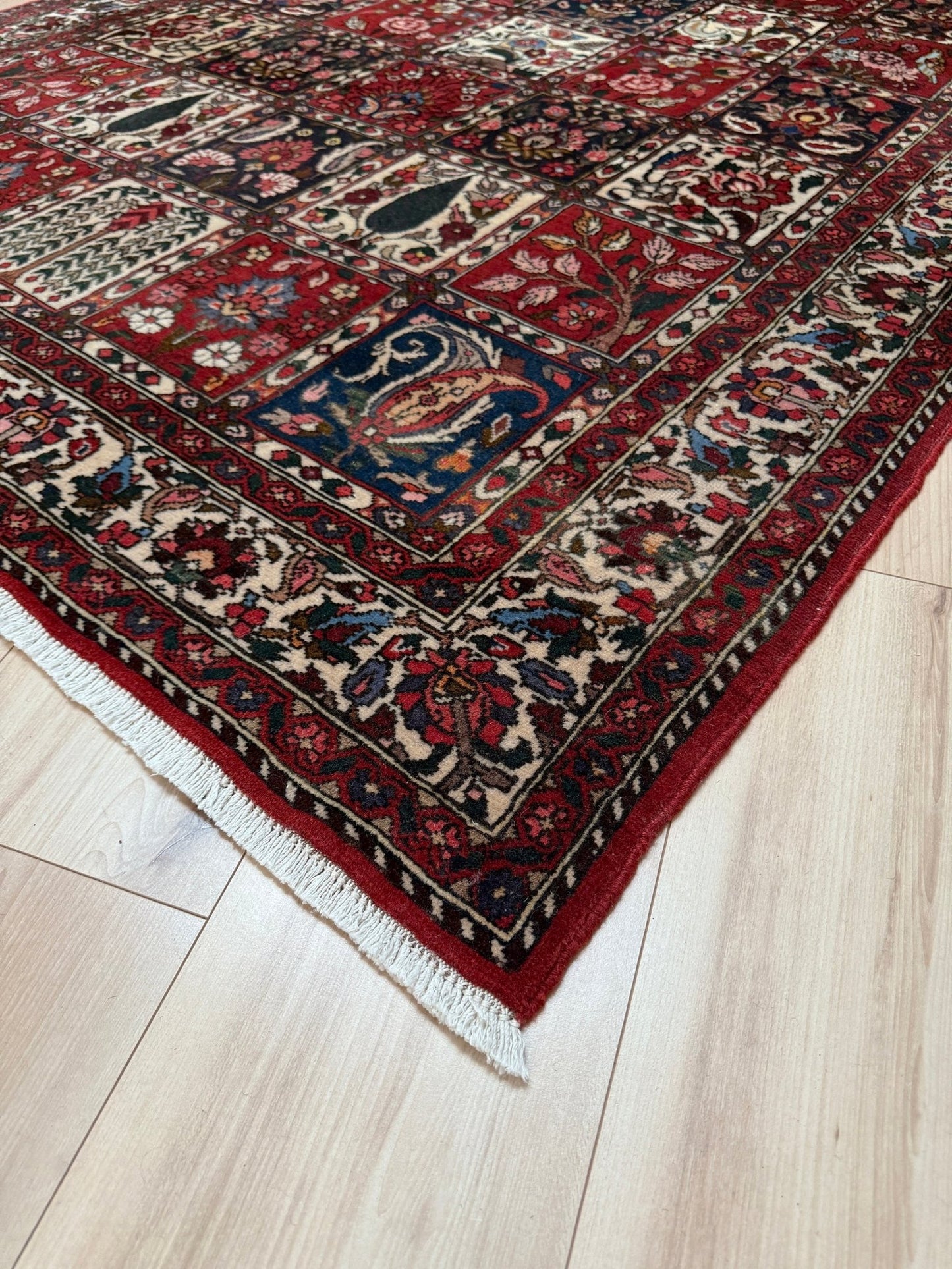 Vintage Persian Bakhtiari rug wit red field, navy garden panels, ivory details, and intricate floral motifs, handmade wool area rug 5x8 from Indigo Rugs Burlingame SF Bay Area