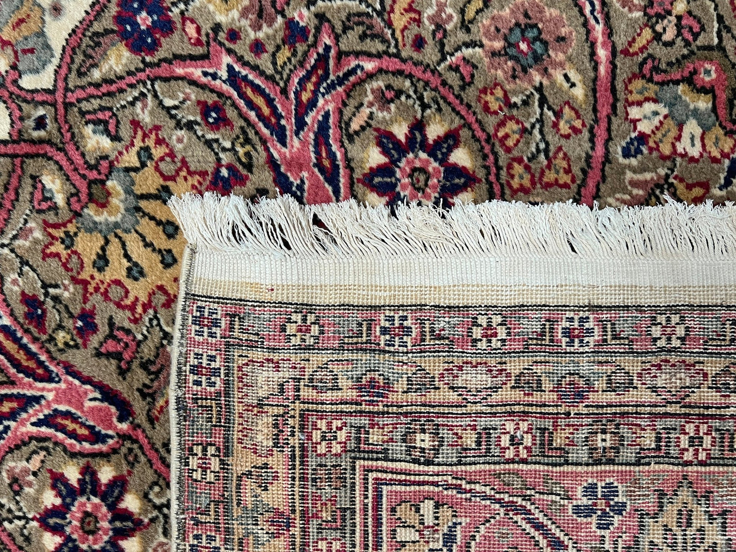 Back detail of a pink and brown vintage Kayseri Turkish rug, highlighting the intricate floral patterns and fine craftsmanship. This luxurious 9x12 handmade wool carpet is available in the San Francisco Bay Area with free shipping, perfect for adding a touch of elegance to any home decor.