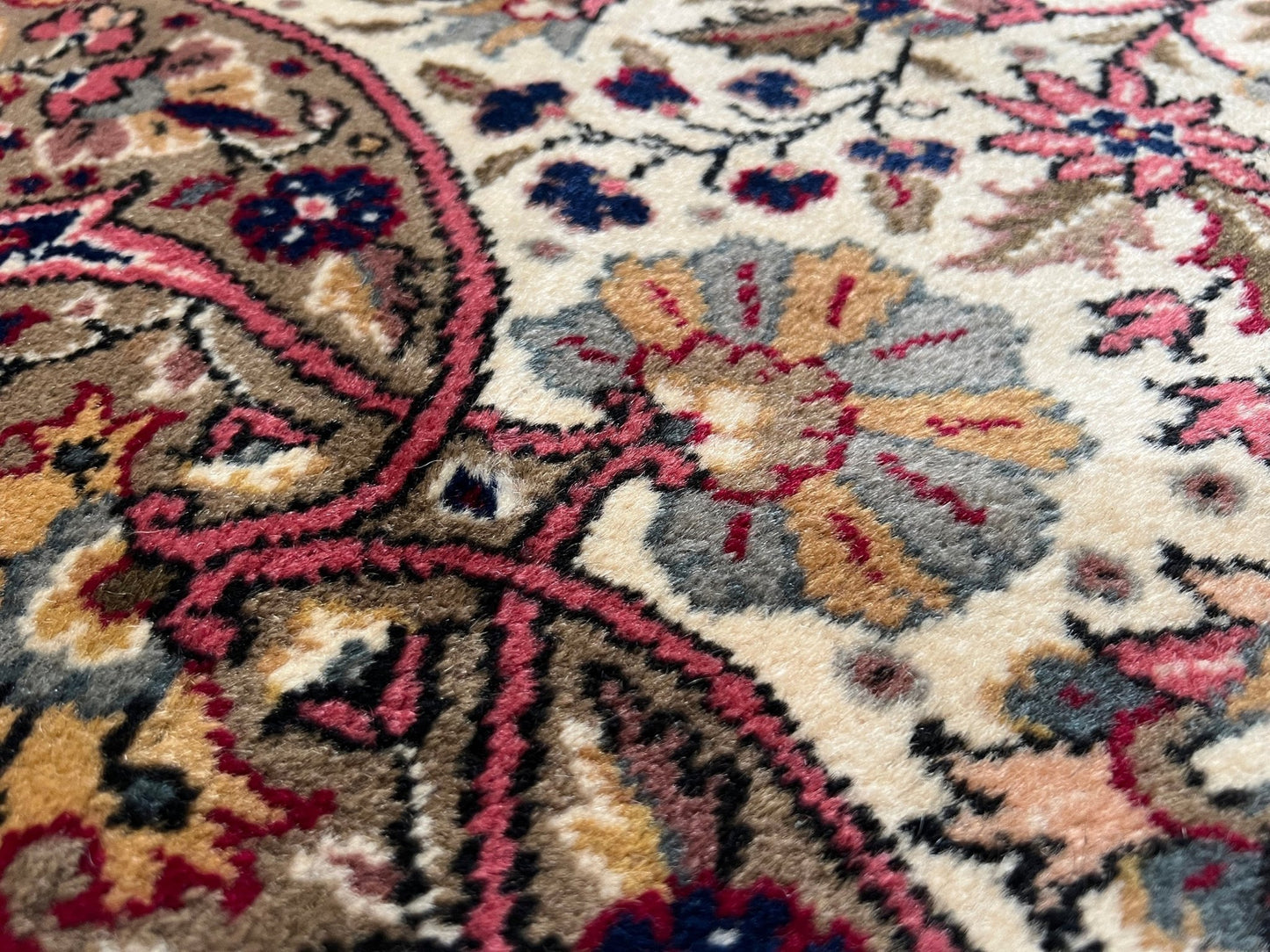 Close-up detail of a pink and brown vintage Kayseri Turkish rug. This luxurious 9x12 handmade wool carpet is available in the San Francisco Bay Area with free shipping, perfect for adding a touch of elegance to any home decor.