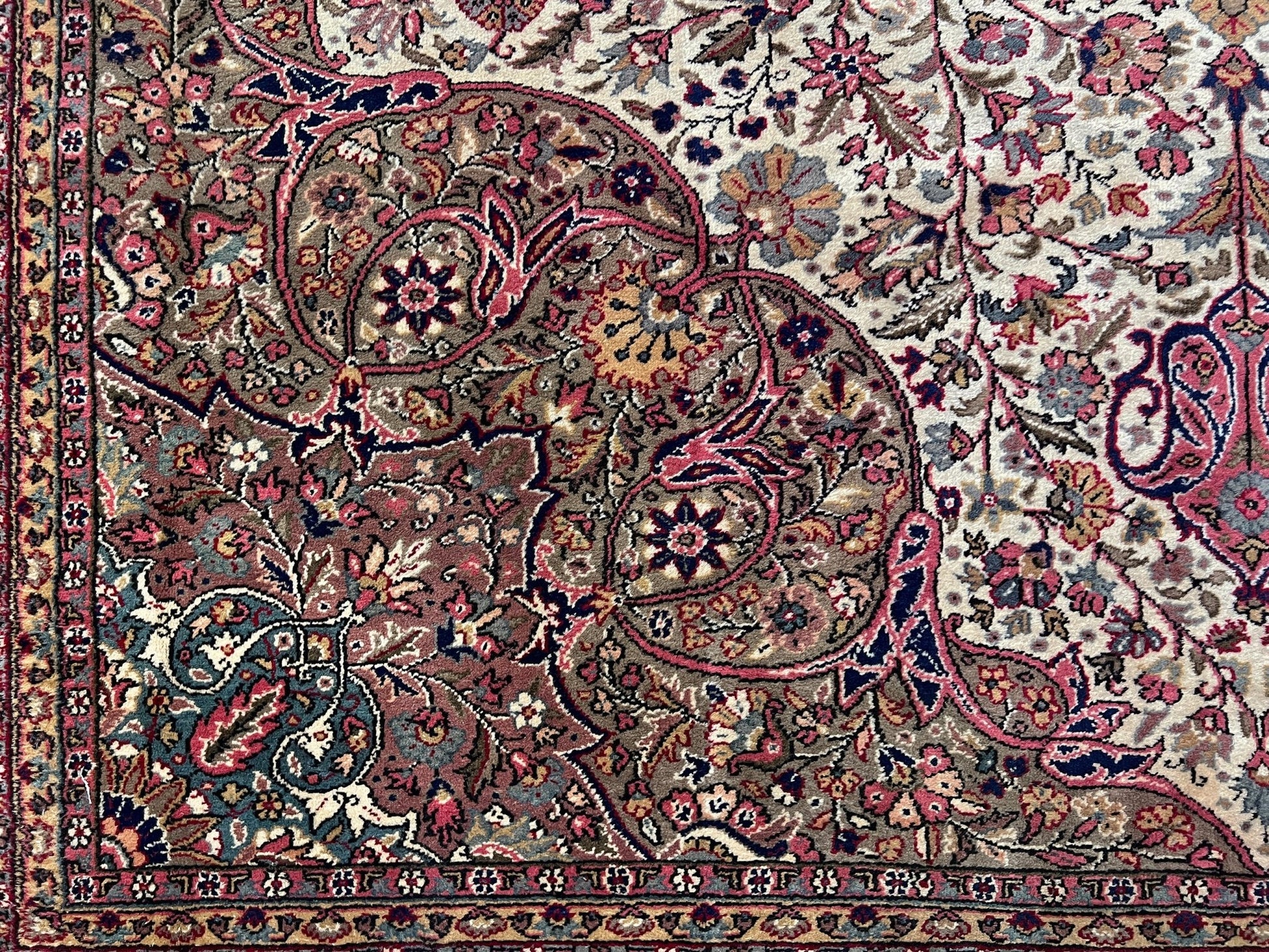 Corner detail of a pink and brown vintage Kayseri Turkish rug, highlighting the intricate floral patterns and fine craftsmanship. This luxurious 9x12 handmade wool carpet is available in the San Francisco Bay Area with free shipping, perfect for adding a touch of elegance to any home decor.