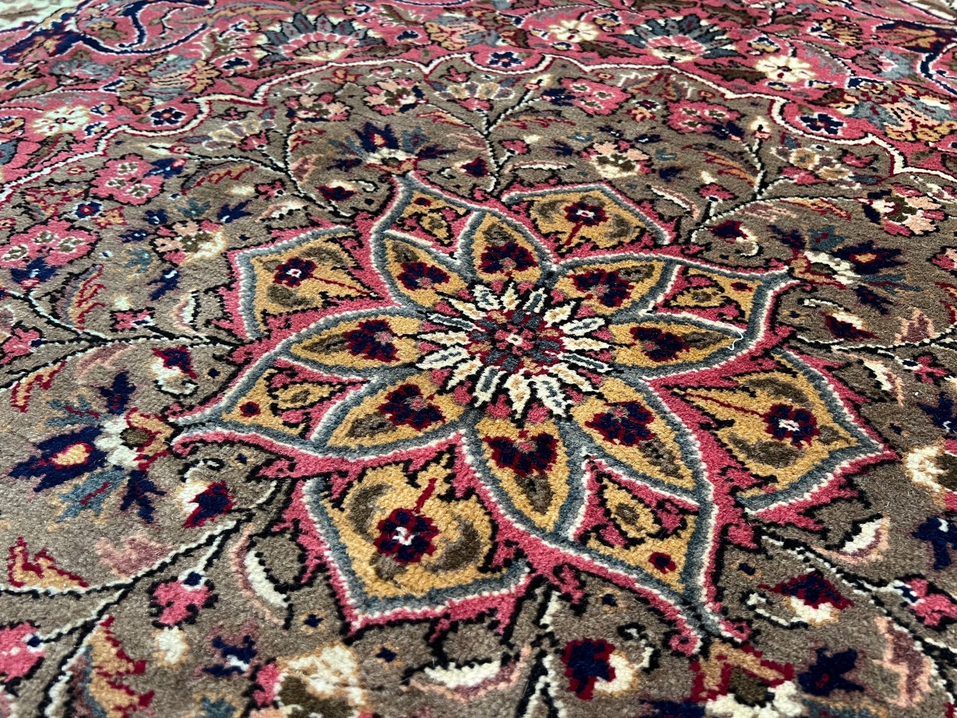 Medallion detail of a pink and brown floral vintage Kayseri Turkish rug. This luxurious 9x12 handmade wool carpet is available in the San Francisco Bay Area with free shipping, perfect for adding a touch of elegance to any home decor.