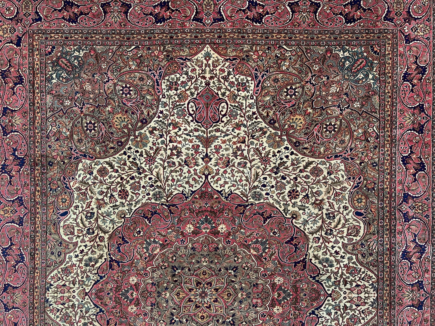 Detail of the intricate floral patterns and fine craftsmanship of a pink and brown vintage Kayseri Turkish rug. This luxurious 9x12 handmade wool carpet is available in the San Francisco Bay Area with free shipping, perfect for adding a touch of elegance to any home decor.