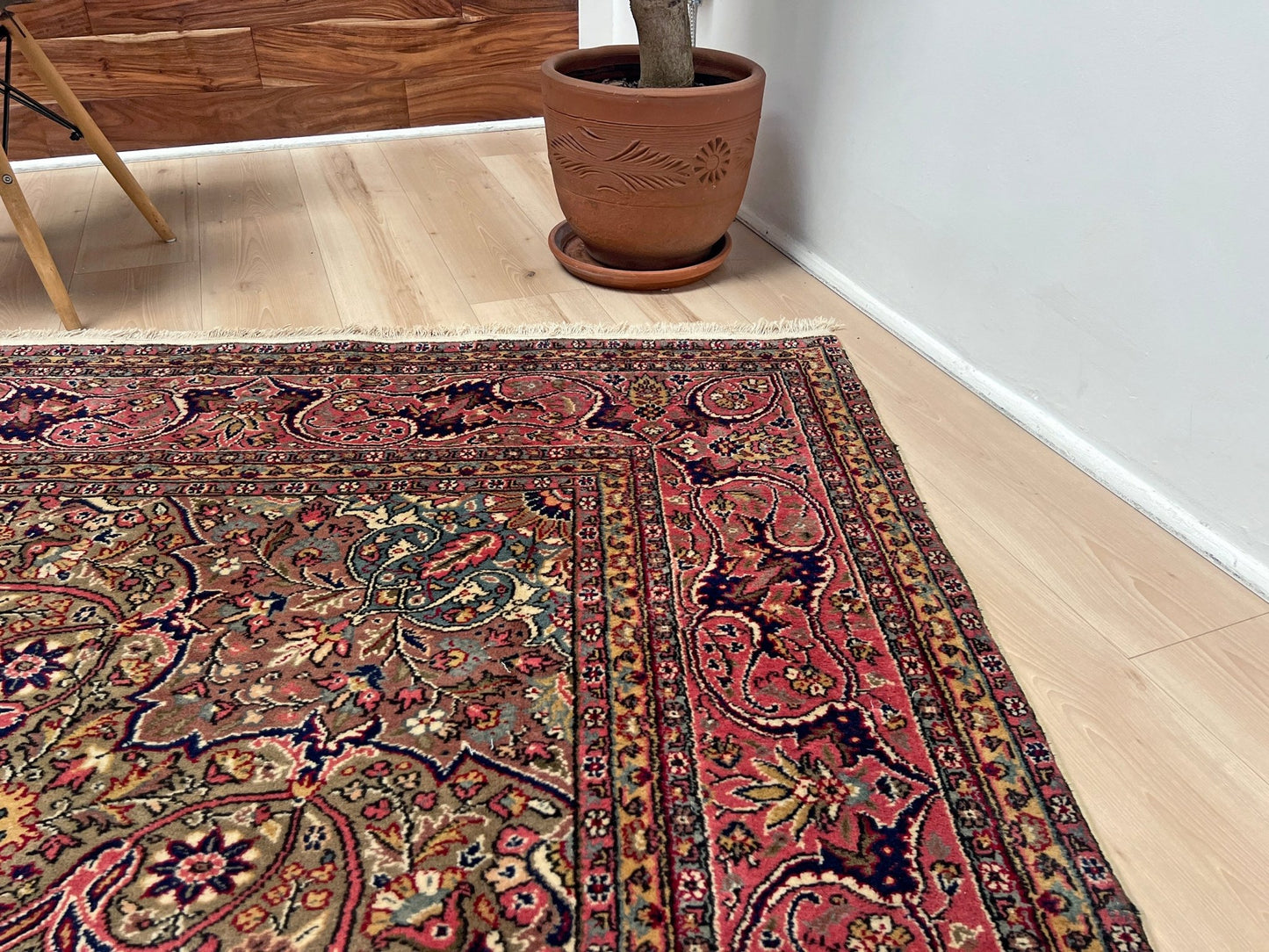 Corner border detail of a pink and brown vintage Kayseri Turkish rug, highlighting the intricate floral patterns and fine craftsmanship. This luxurious 9x12 handmade wool carpet is available in the San Francisco Bay Area with free shipping, perfect for adding a touch of elegance to any home decor.