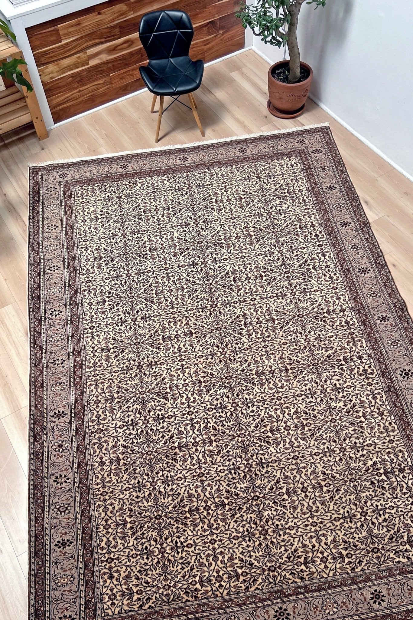 Side angled picture of Neutral Kayseri Turkish Rug in a modern living room setting, showcasing an 8x12 handmade wool carpet with a floral pattern, made from undyed wool. Ideal for adding elegance to a living room, bedroom, dining room, or office decor. Free shipping from our rug shop in San Francisco Bay Area to USA and Canada.