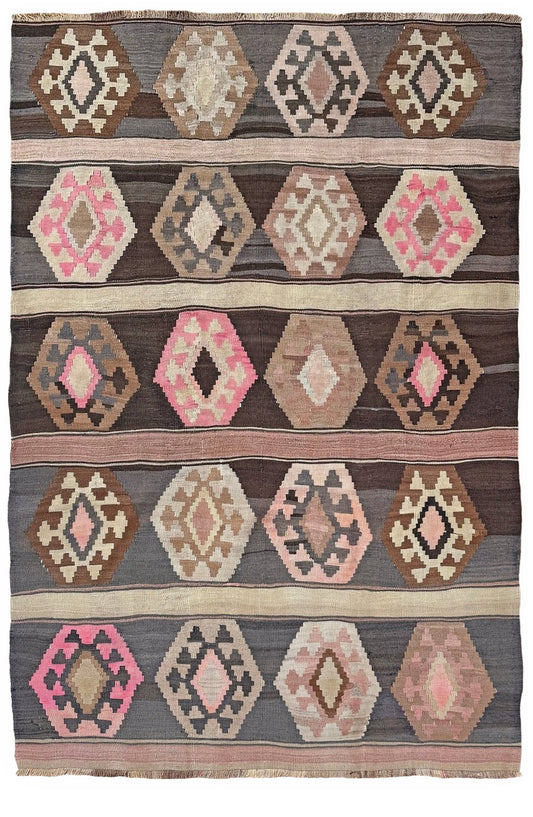 A flat-weave kilim rug with a geometric pattern featuring rows of hexagonal and diamond motifs in shades of brown, beige, pink, and gray. Handmade wool 6x9 rug from Indigo Rugs Burlingame Bay Area.