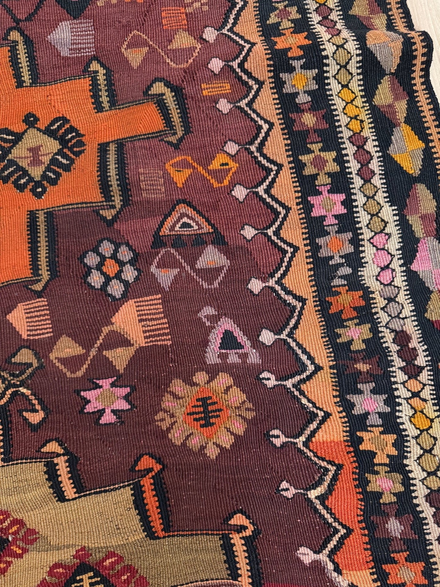 Vintage Kurdish Kars kilim, featuring maroon red and chestnut brown field, geometric medallions, symbolic tribal motifs and protective symbols, handwoven wool 5x10 flatweave rug 