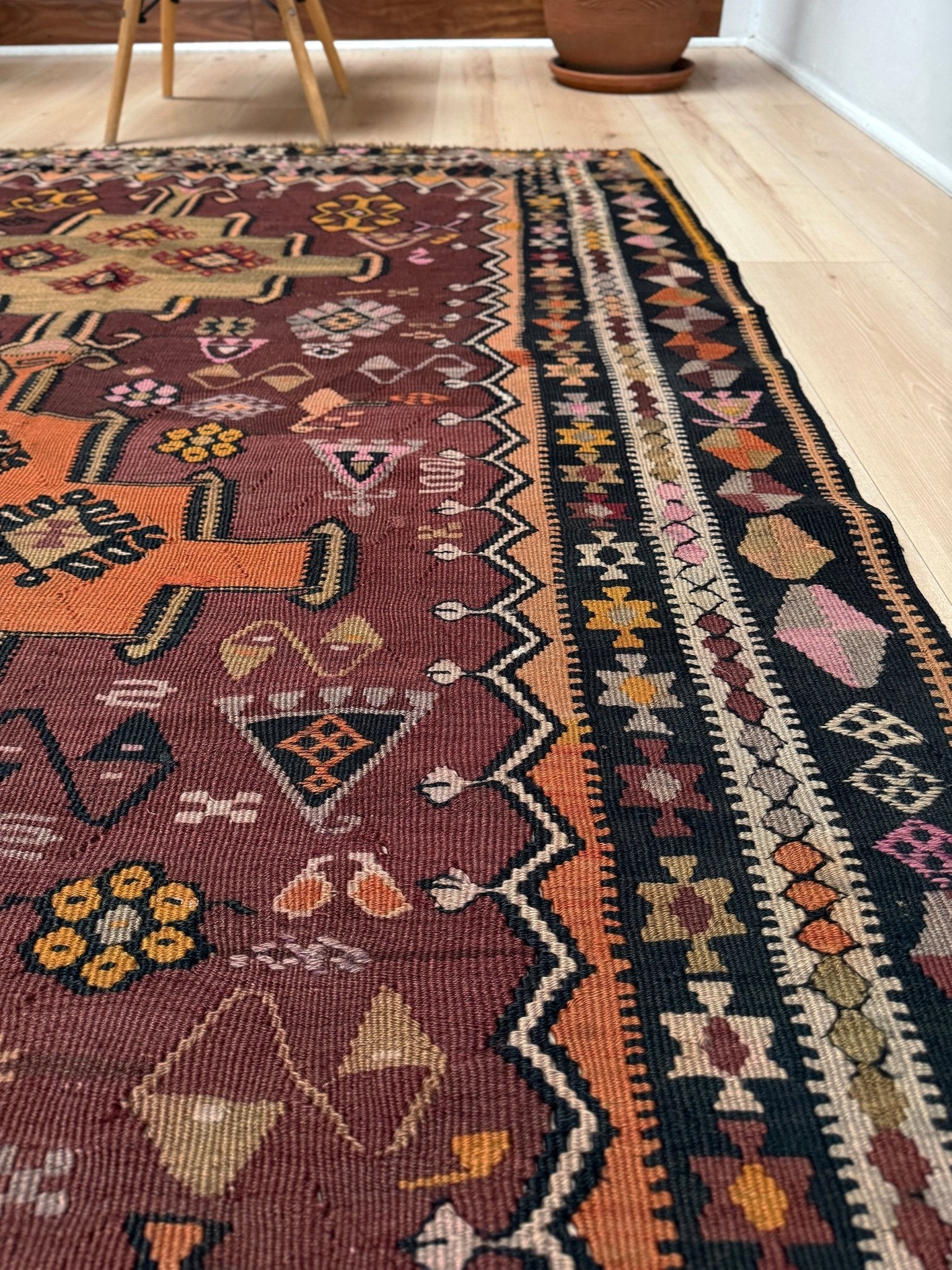 Vintage Kurdish Kars kilim, featuring maroon red and chestnut brown field, geometric medallions, symbolic tribal motifs and protective symbols, handwoven wool 5x10 flatweave rug 