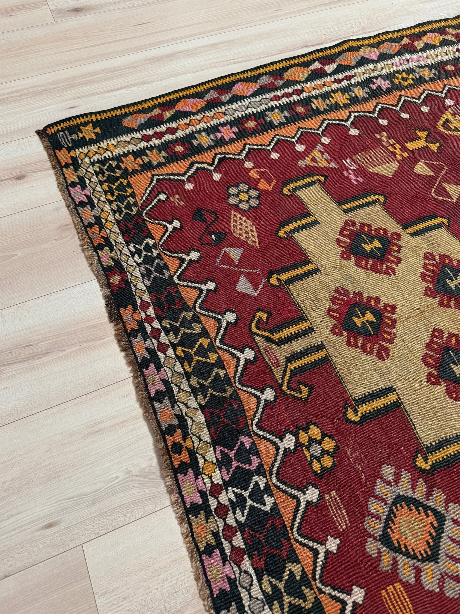 Vintage Kurdish Kars kilim, featuring maroon red and chestnut brown field, geometric medallions, symbolic tribal motifs and protective symbols, handwoven wool 5x10 flatweave rug 