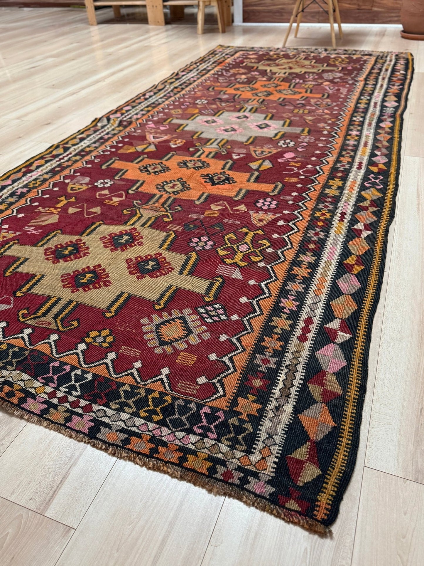 Vintage Kurdish Kars kilim, featuring maroon red and chestnut brown field, geometric medallions, symbolic tribal motifs and protective symbols, handwoven wool 5x10 flatweave rug 