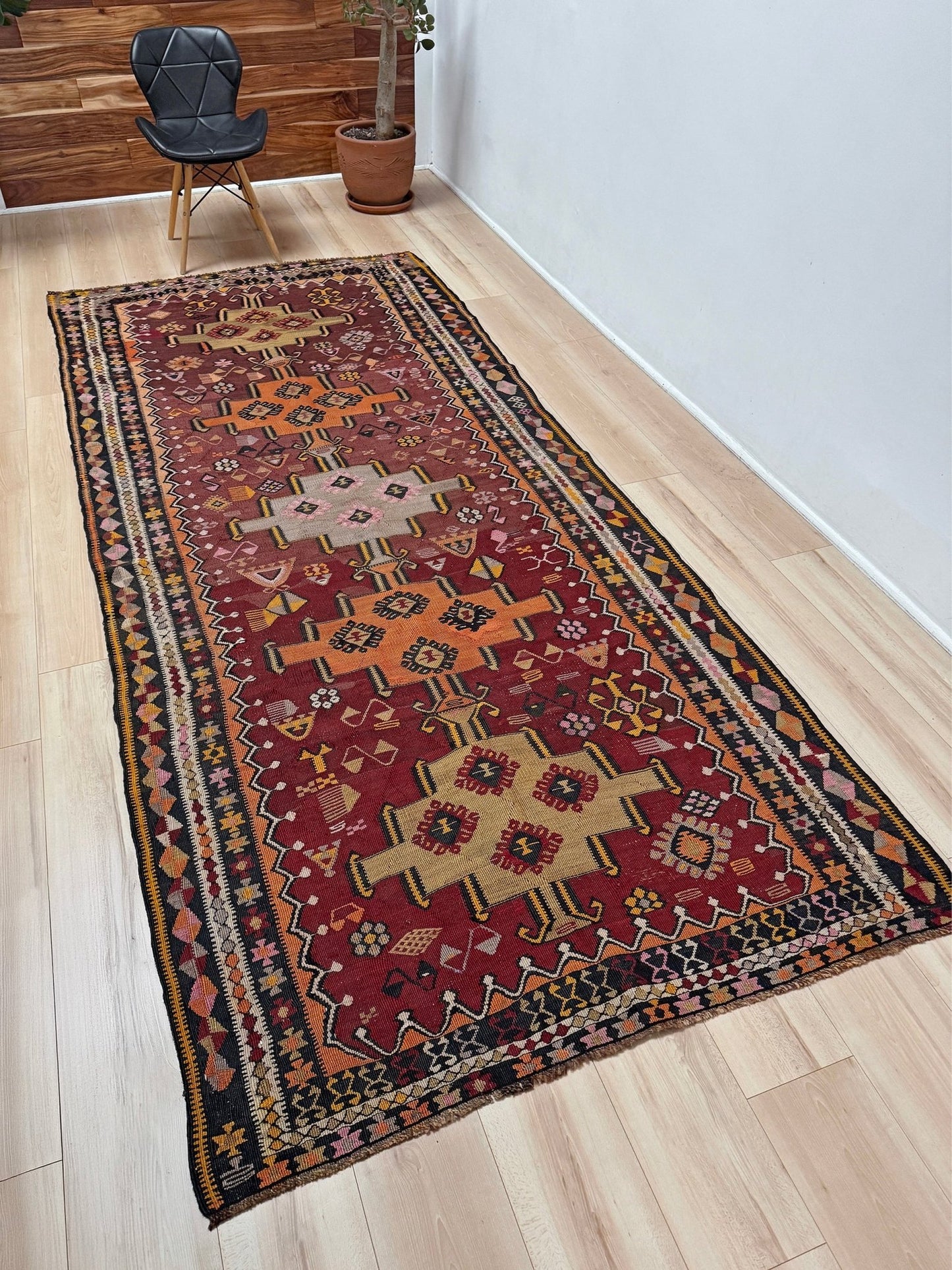 Vintage Kurdish Kars kilim, featuring maroon red and chestnut brown field, geometric medallions, symbolic tribal motifs and protective symbols, handwoven wool 5x10 flatweave rug 