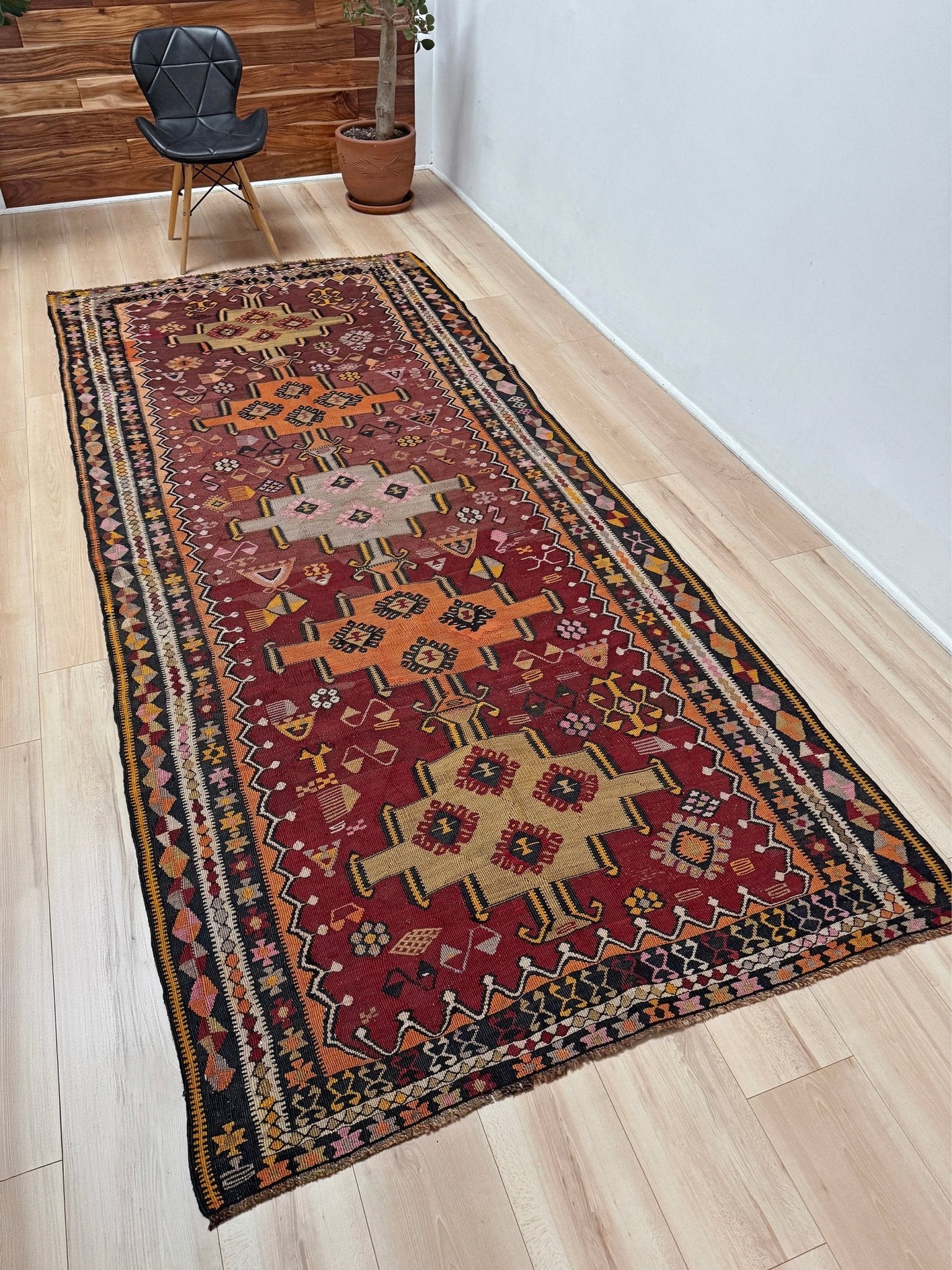 Vintage Kurdish Kars kilim, featuring maroon red and chestnut brown field, geometric medallions, symbolic tribal motifs and protective symbols, handwoven wool 5x10 flatweave rug 