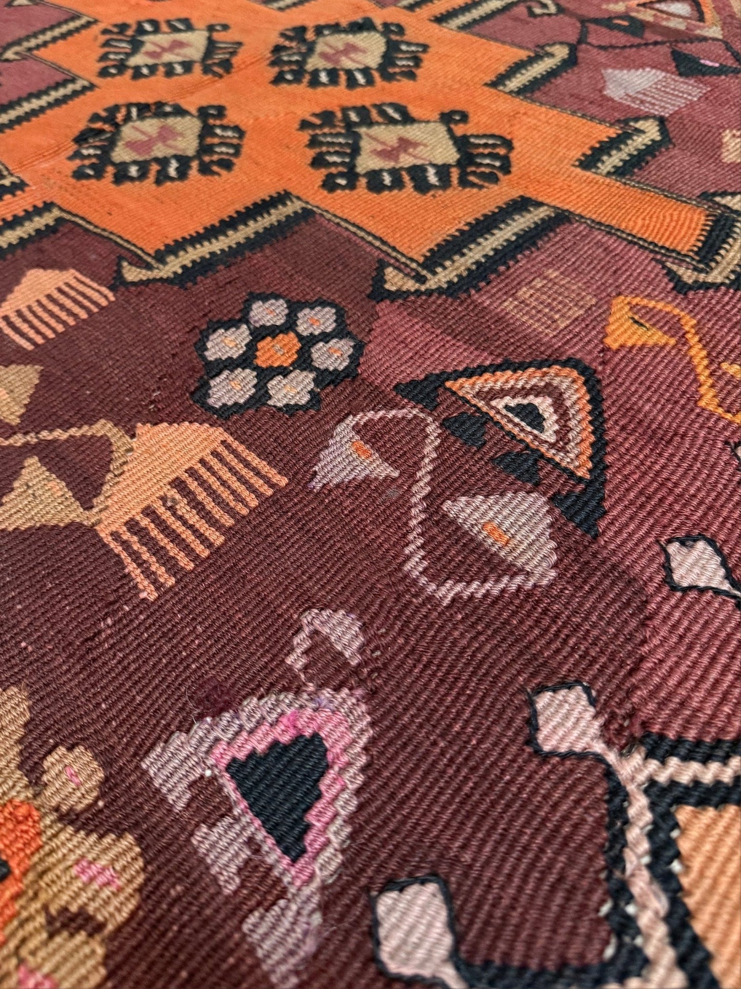 Vintage Kurdish Kars kilim, featuring maroon red and chestnut brown field, geometric medallions, symbolic tribal motifs and protective symbols, handwoven wool 5x10 flatweave rug 