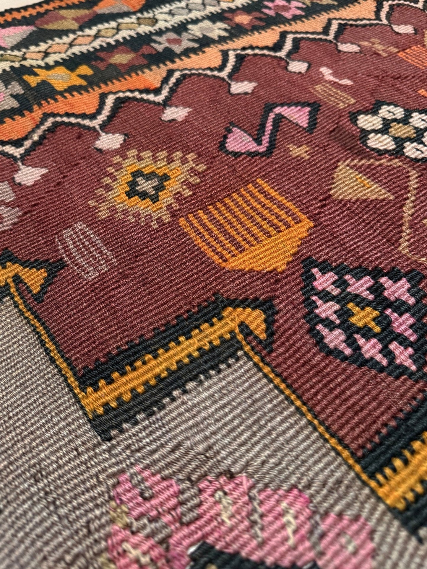 Vintage Kurdish Kars kilim, featuring maroon red and chestnut brown field, geometric medallions, symbolic tribal motifs and protective symbols, handwoven wool 5x10 flatweave rug 