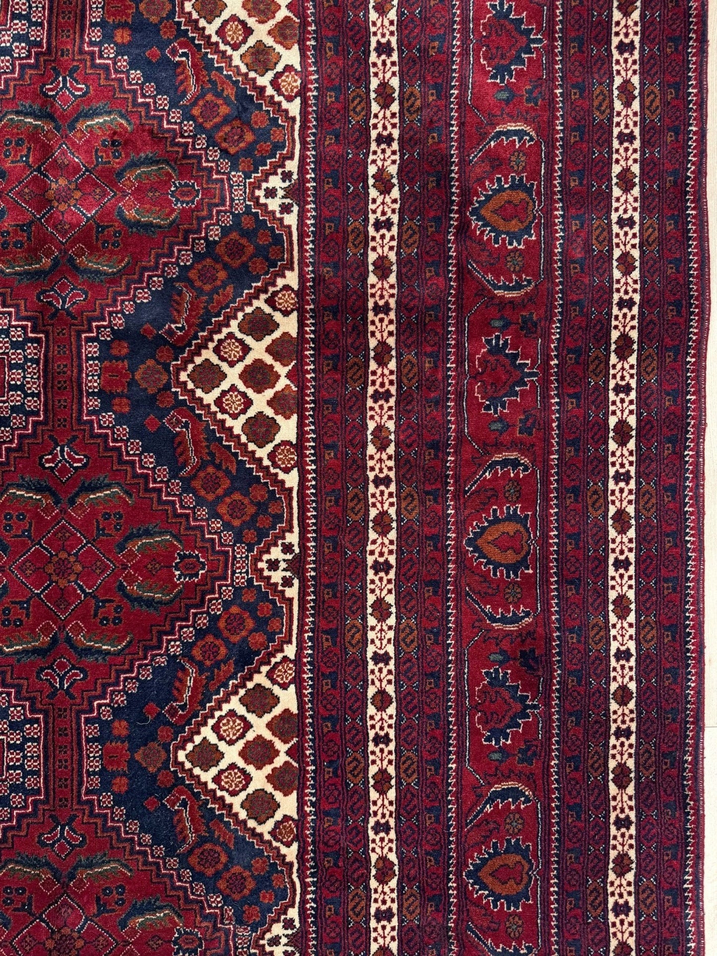 Deep crimson Khal Mohammadi Afghan rug with classic Turkmen gul medallions, dark navy border, ivory details, burgundy, terracotta, beige and forest green accents, handmade Merino wool 10x14 from Indigo Rugs Burlingame Bay Area.
