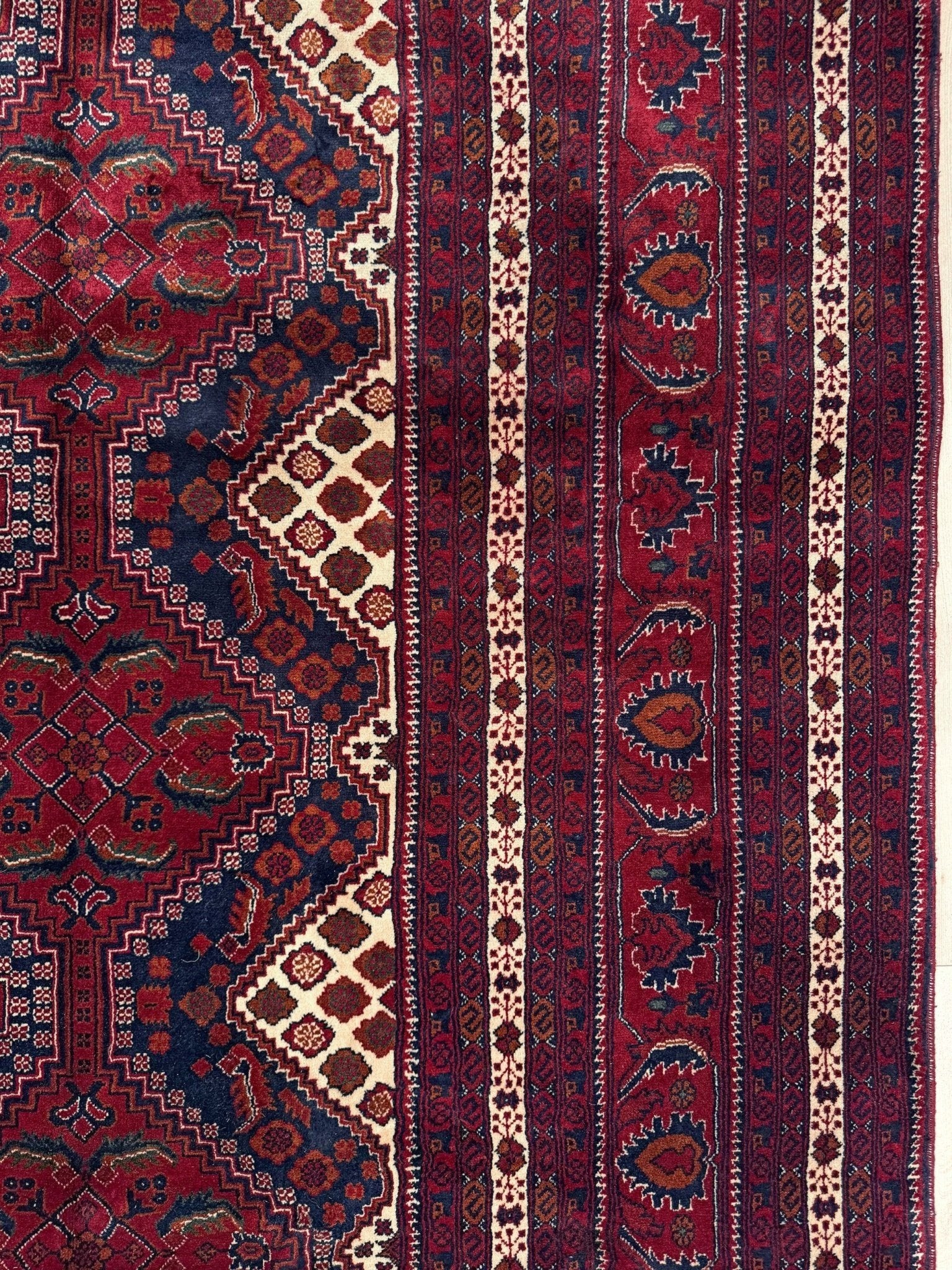 Deep crimson Khal Mohammadi Afghan rug with classic Turkmen gul medallions, dark navy border, ivory details, burgundy, terracotta, beige and forest green accents, handmade Merino wool 10x14 from Indigo Rugs Burlingame Bay Area.