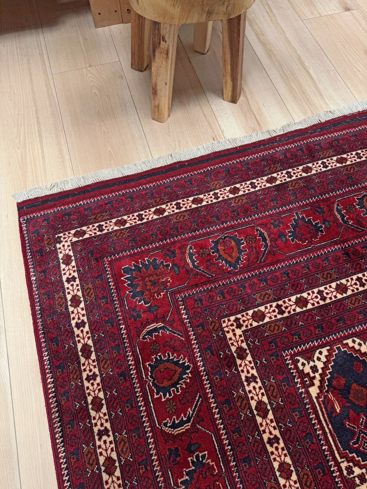 Deep crimson Khal Mohammadi Afghan rug with classic Turkmen gul medallions, dark navy border, ivory details, burgundy, terracotta, beige and forest green accents, handmade Merino wool 10x14 from Indigo Rugs Burlingame Bay Area.