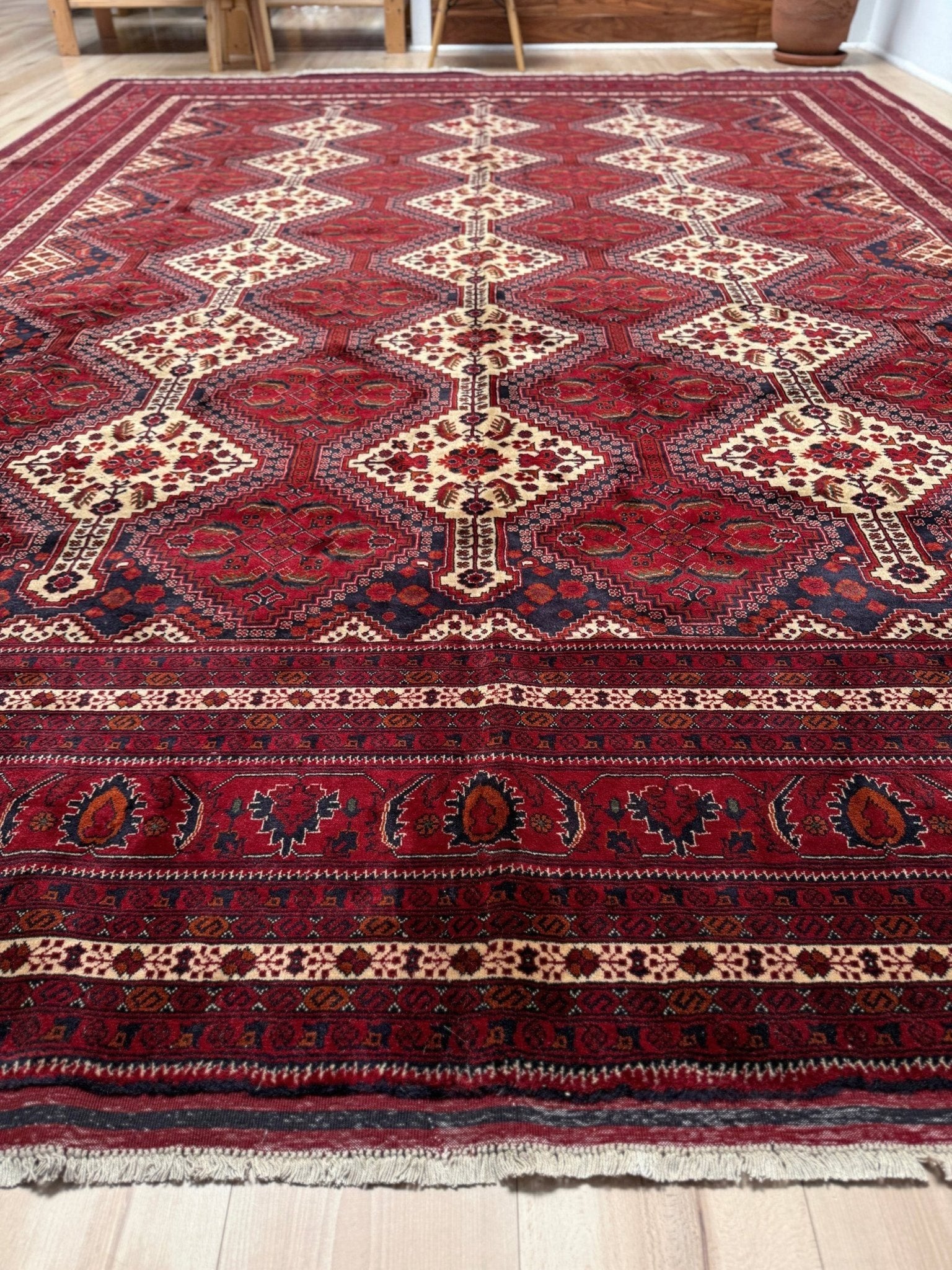 Deep crimson Khal Mohammadi Afghan rug with classic Turkmen gul medallions, dark navy border, ivory details, burgundy, terracotta, beige and forest green accents, handmade Merino wool 10x14 from Indigo Rugs Burlingame Bay Area.
