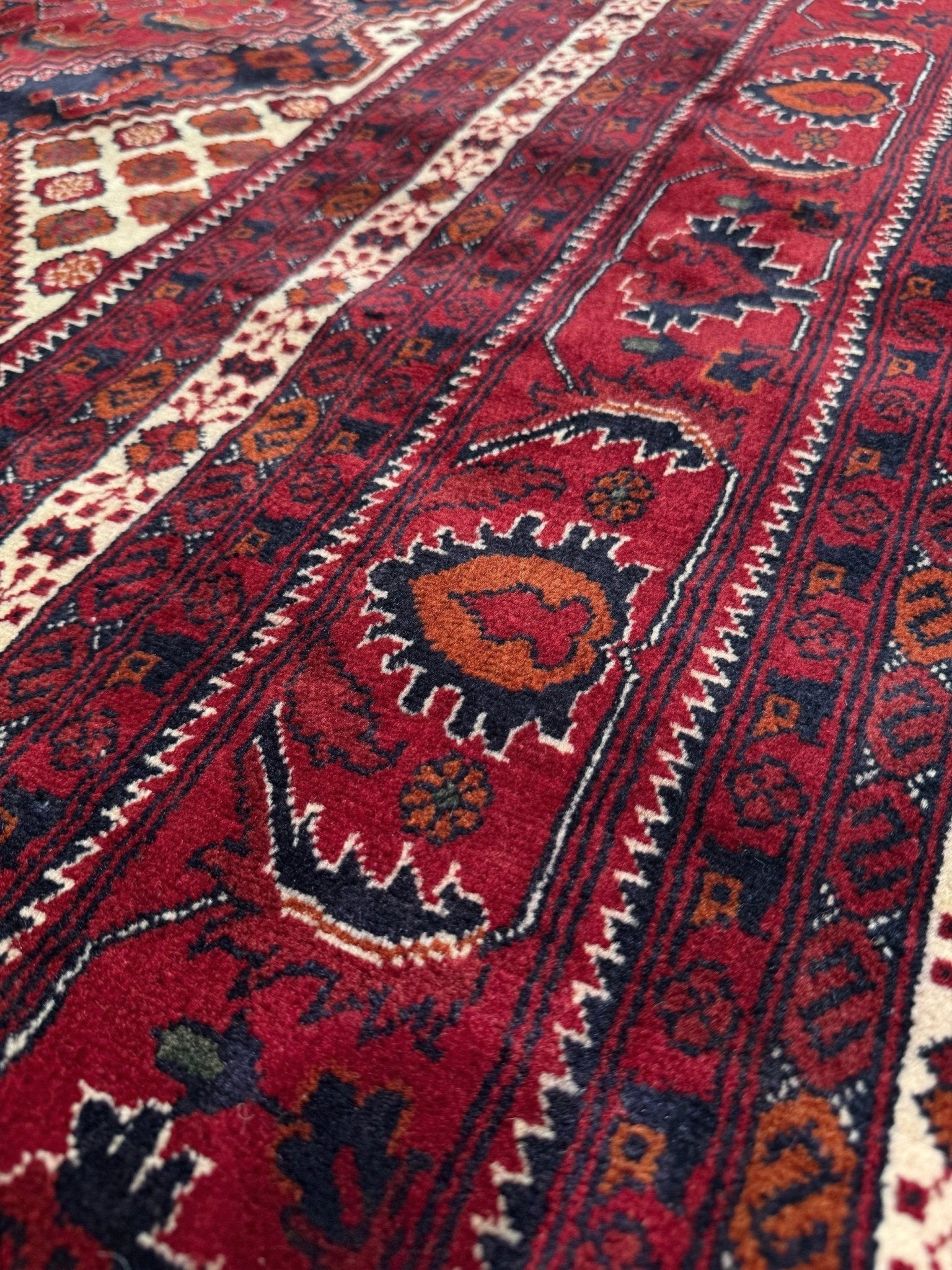 Deep crimson Khal Mohammadi Afghan rug with classic Turkmen gul medallions, dark navy border, ivory details, burgundy, terracotta, beige and forest green accents, handmade Merino wool 10x14 from Indigo Rugs Burlingame Bay Area.