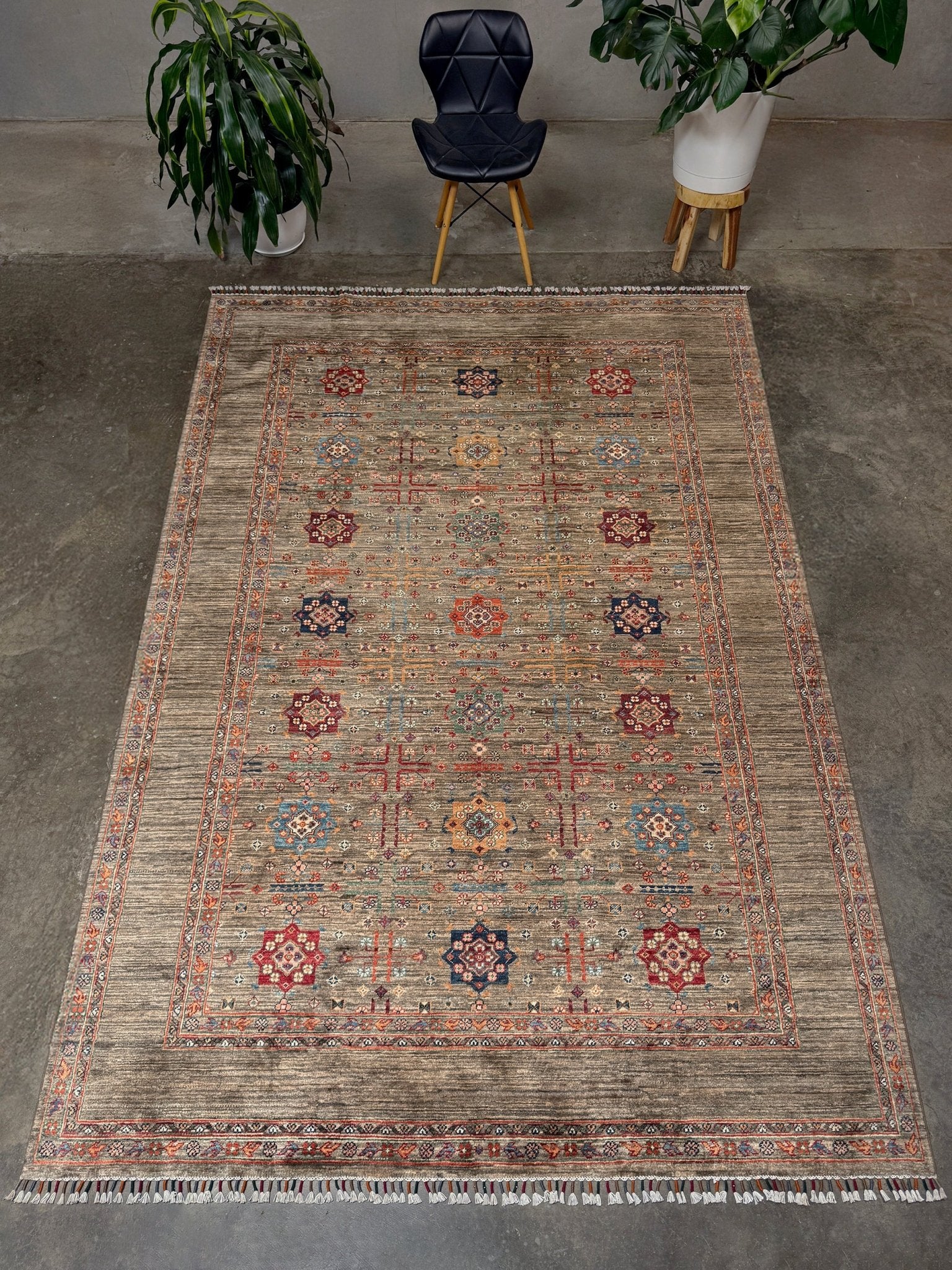 Contemporary Bilcik Turkmen 7x10 rug with dusted olive taupe field, colorful tribal motifs, decorative tassels, handmade Ghazni wool area rug from Indigo Rugs Burlingame Bay Area.