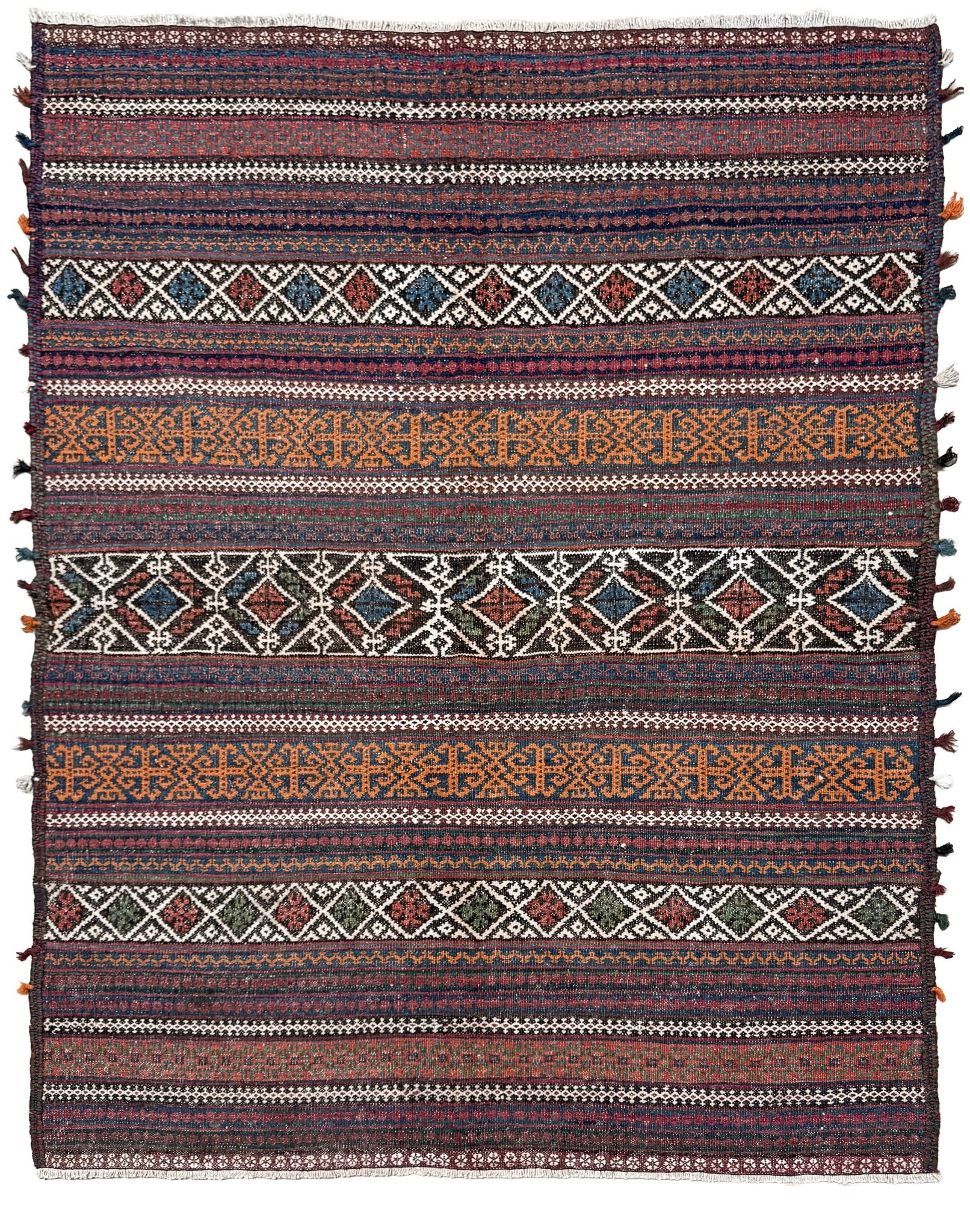 Patterned rug with multicolor stripes and geometric designs on a white background. Vintage Persian tribal kilim rug with geometric horizontal bands, brick red, indigo blue, orange, decorative side tassels, handmade wool flatweave 5x6 from Indigo Rugs Burlingame Bay Area.