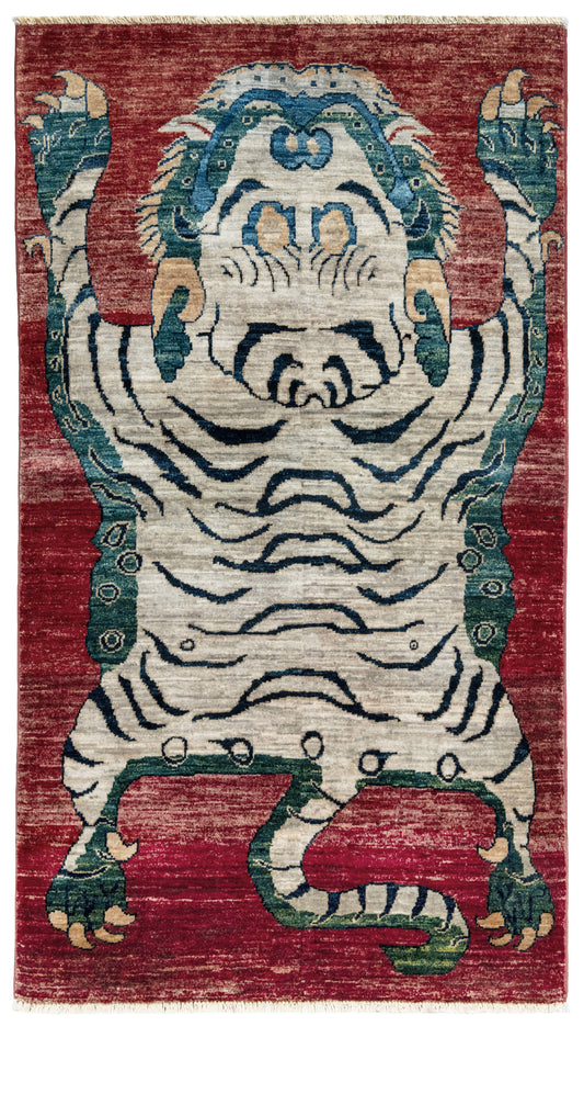 Rug with a tiger design on a red background. Brand new Tibetan tiger rug with rust red, ivory tiger, teal blue, handmade wool accent rug 3x5 from Indigo Rugs Burlingame Bay Area.