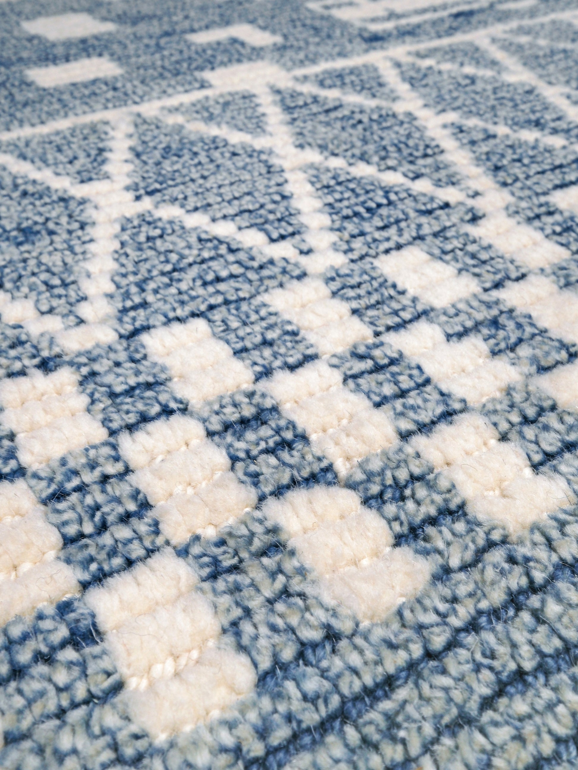 Small blue Turkish Tulu rug with ivory geometric motifs, checker details and textured wool pile, handmade wool rug 4x6 from Indigo Rugs Burlingame Bay Area.