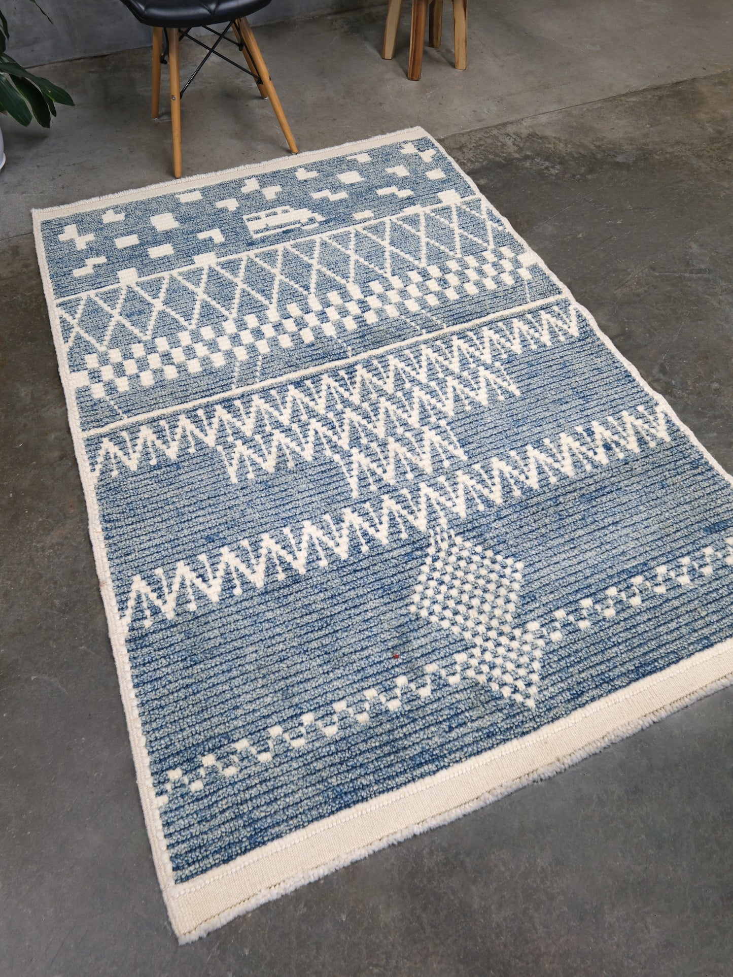 Small blue Turkish Tulu rug with ivory geometric motifs, checker details and textured wool pile, handmade wool rug 4x6 from Indigo Rugs Burlingame Bay Area.