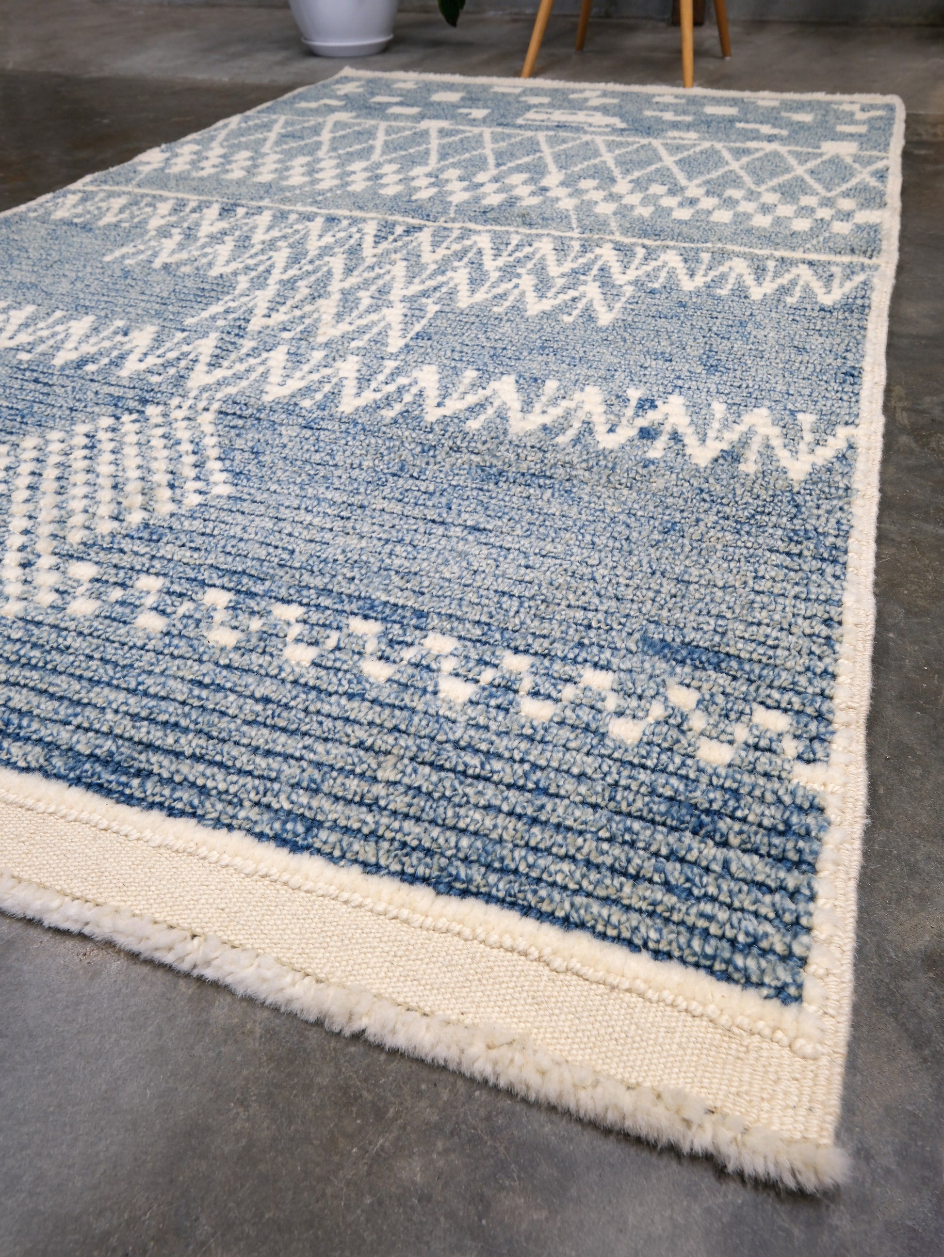 Small blue Turkish Tulu rug with ivory geometric motifs, checker details and textured wool pile, handmade wool rug 4x6 from Indigo Rugs Burlingame Bay Area.