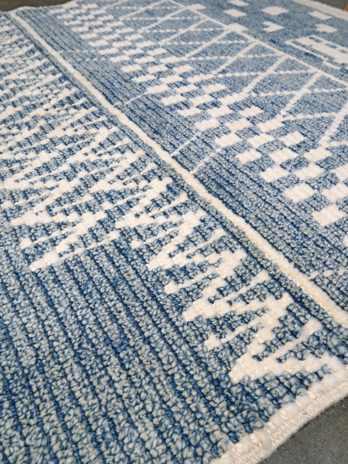 Small blue Turkish Tulu rug with ivory geometric motifs, checker details and textured wool pile, handmade wool rug 4x6 from Indigo Rugs Burlingame Bay Area.