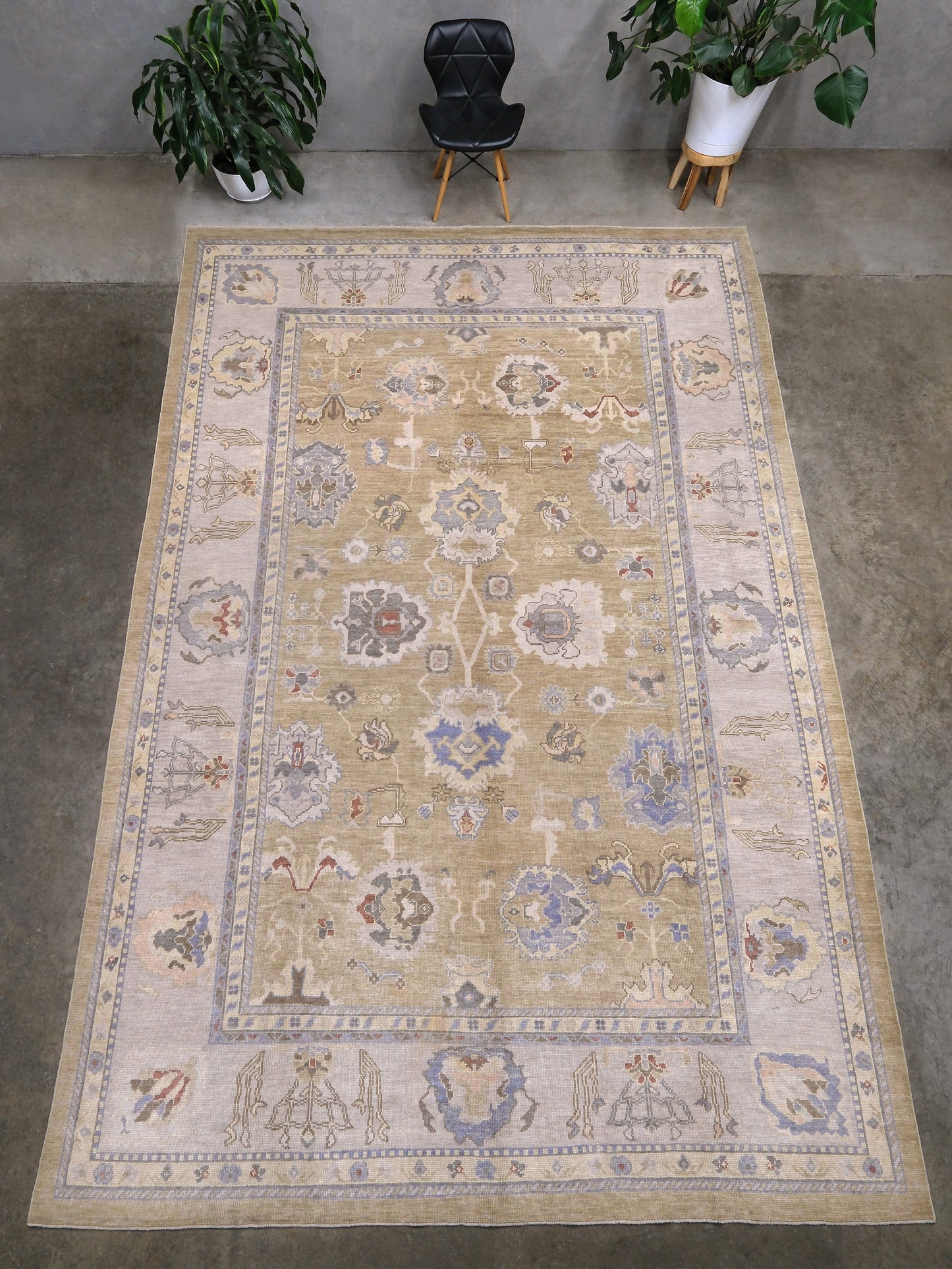 Light olive Turkish Oushak rug with warm ivory border, powder blue floral motifs, soft gray, taupe, and rust accents, hand-knotted wool 10x14 area rug from Indigo Rugs Burlingame Bay Area.