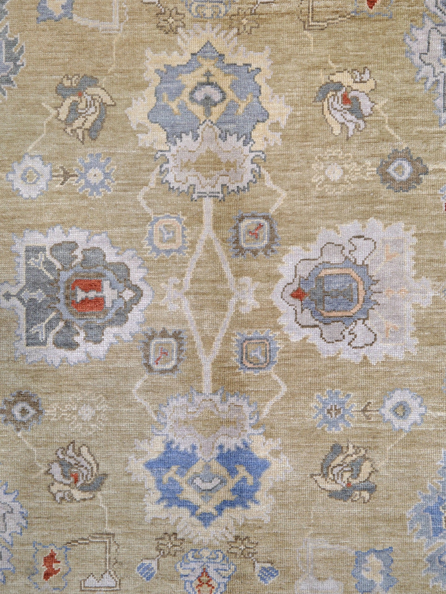 Light olive Turkish Oushak rug with warm ivory border, powder blue floral motifs, soft gray, taupe, and rust accents, hand-knotted wool 10x14 area rug from Indigo Rugs Burlingame Bay Area.