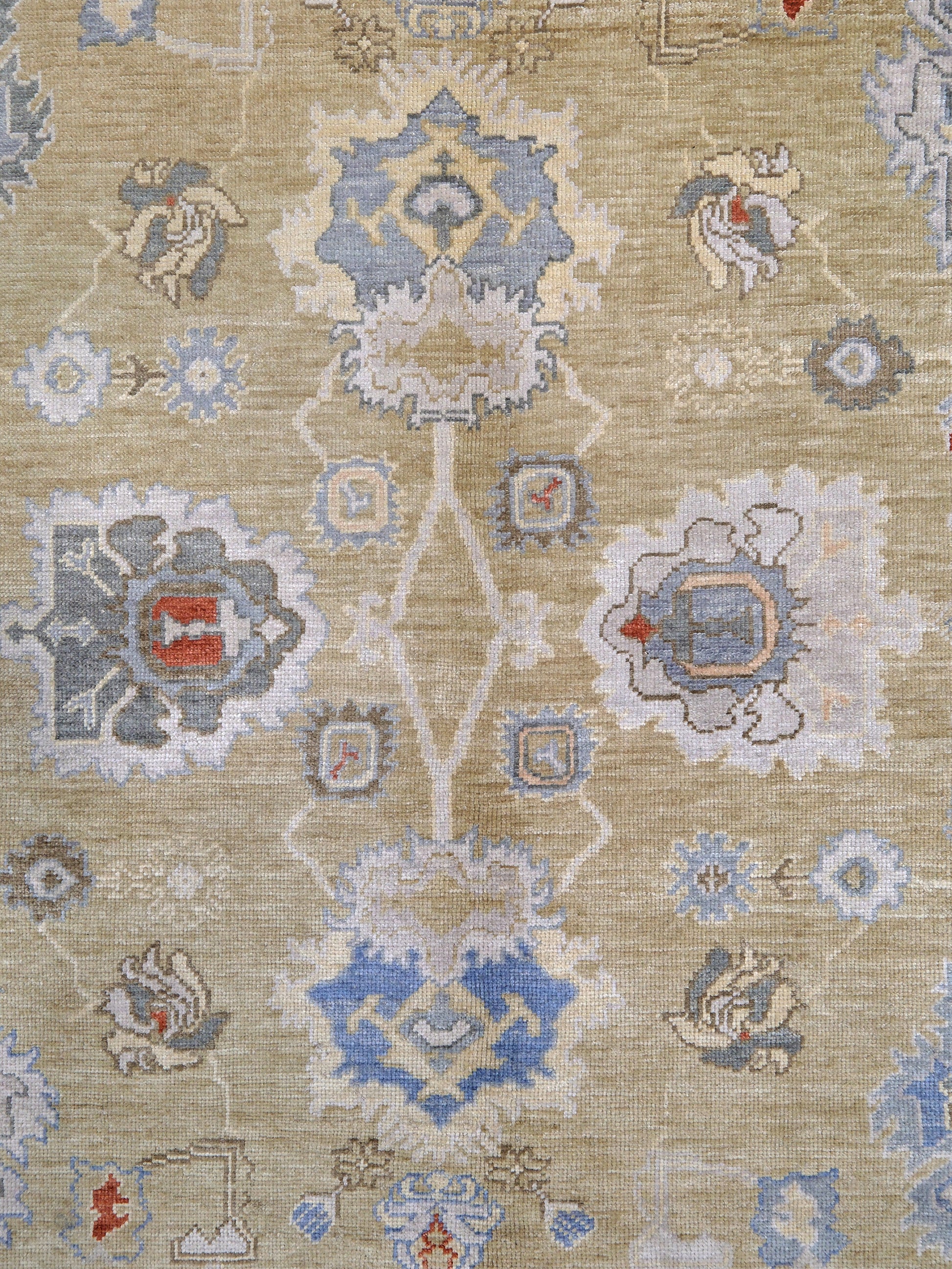 Light olive Turkish Oushak rug with warm ivory border, powder blue floral motifs, soft gray, taupe, and rust accents, hand-knotted wool 10x14 area rug from Indigo Rugs Burlingame Bay Area.