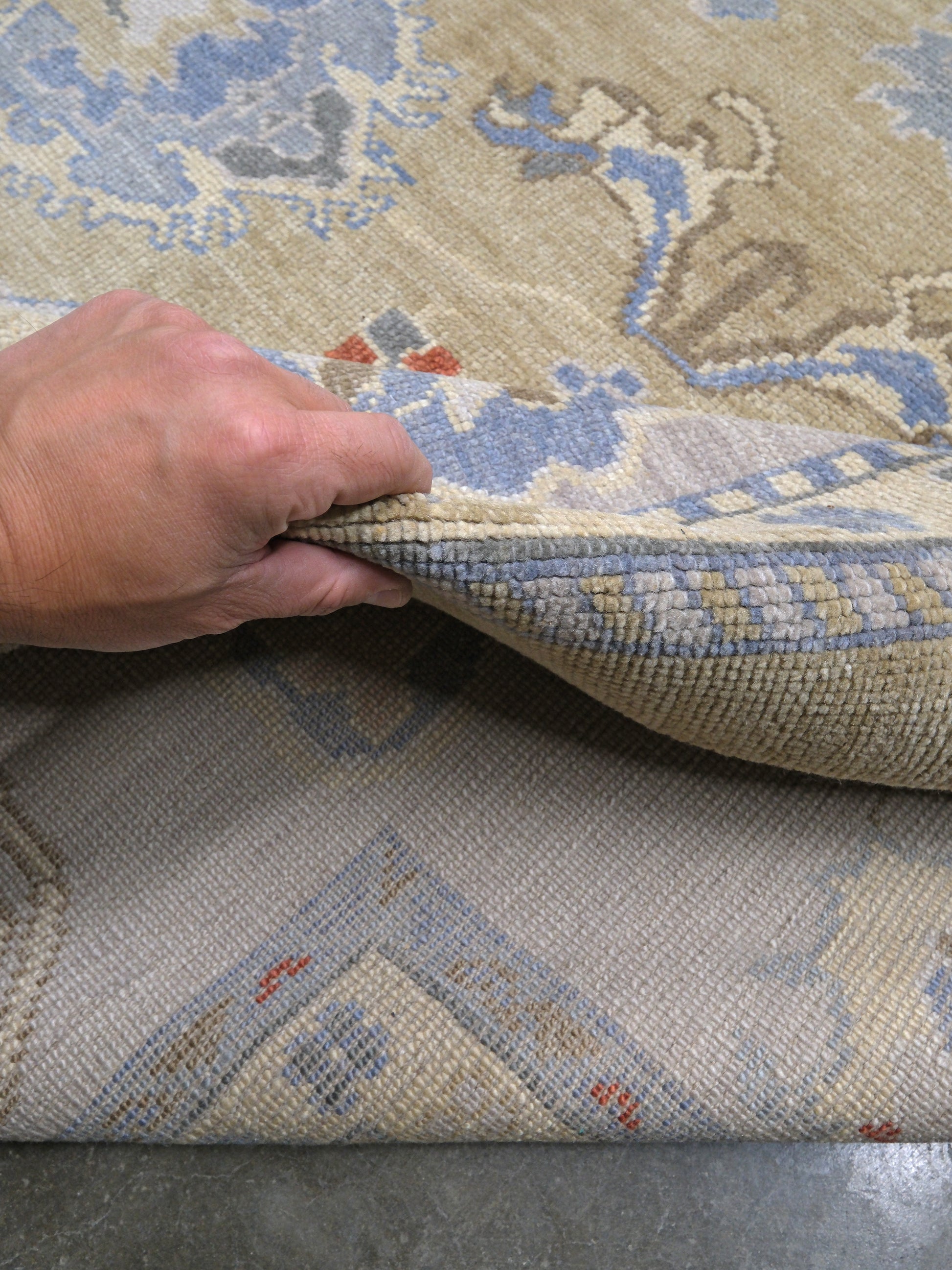 Light olive Turkish Oushak rug with warm ivory border, powder blue floral motifs, soft gray, taupe, and rust accents, hand-knotted wool 10x14 area rug from Indigo Rugs Burlingame Bay Area.