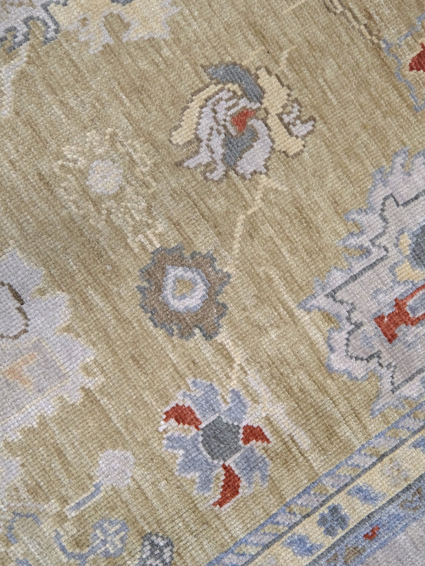 Light olive Turkish Oushak rug with warm ivory border, powder blue floral motifs, soft gray, taupe, and rust accents, hand-knotted wool 10x14 area rug from Indigo Rugs Burlingame Bay Area.