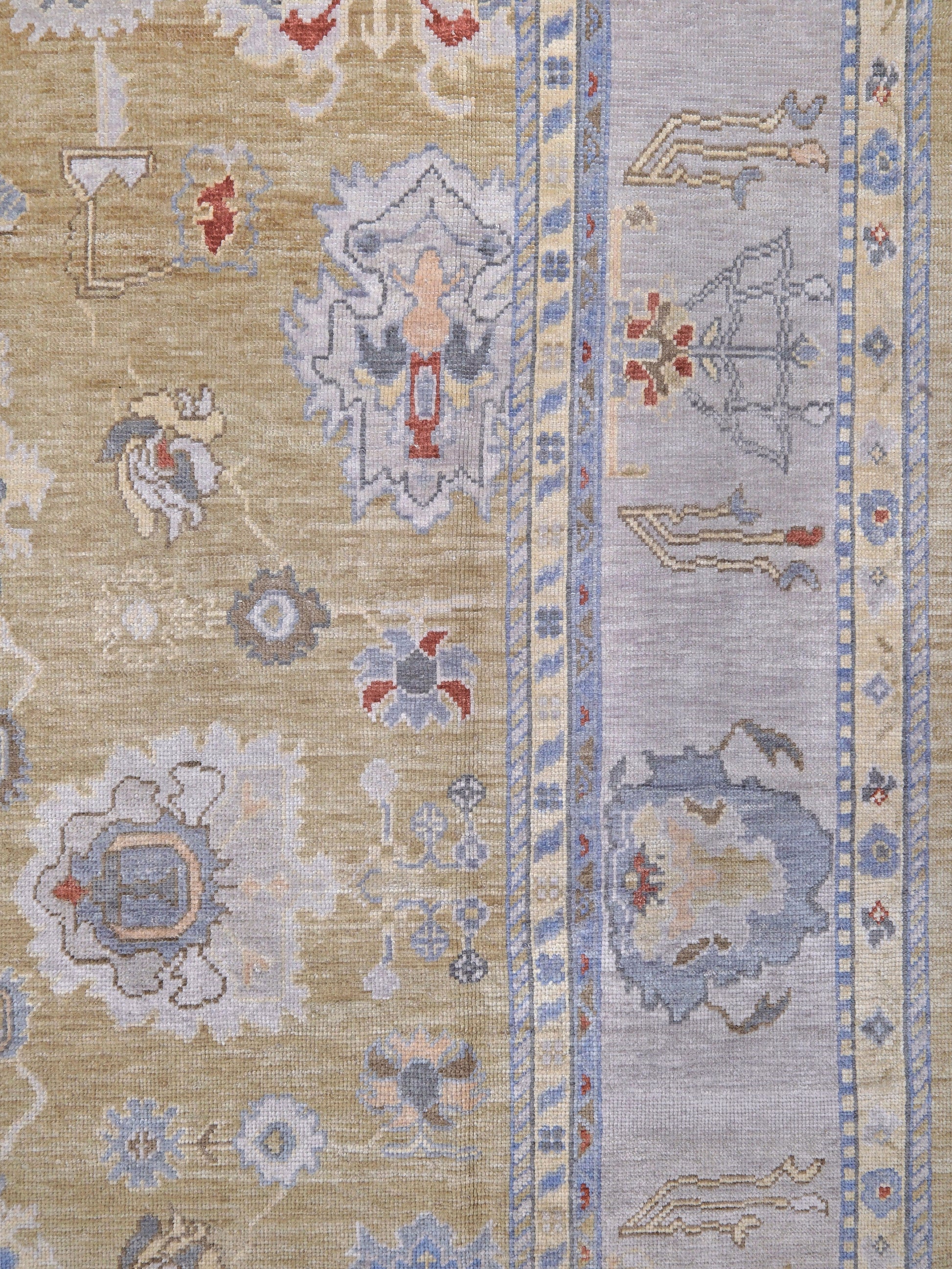 Light olive Turkish Oushak rug with warm ivory border, powder blue floral motifs, soft gray, taupe, and rust accents, hand-knotted wool 10x14 area rug from Indigo Rugs Burlingame Bay Area.