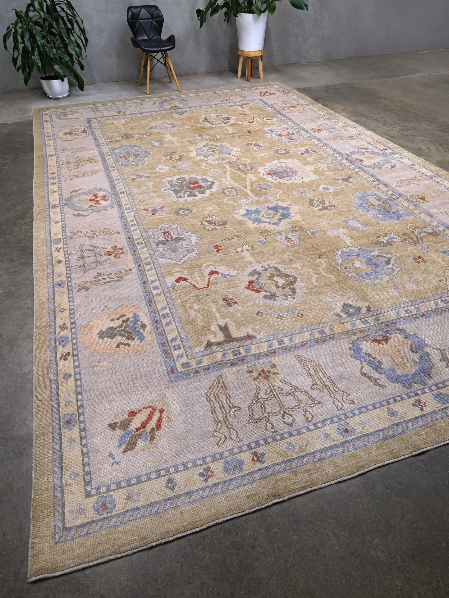Light olive Turkish Oushak rug with warm ivory border, powder blue floral motifs, soft gray, taupe, and rust accents, hand-knotted wool 10x14 area rug from Indigo Rugs Burlingame Bay Area.