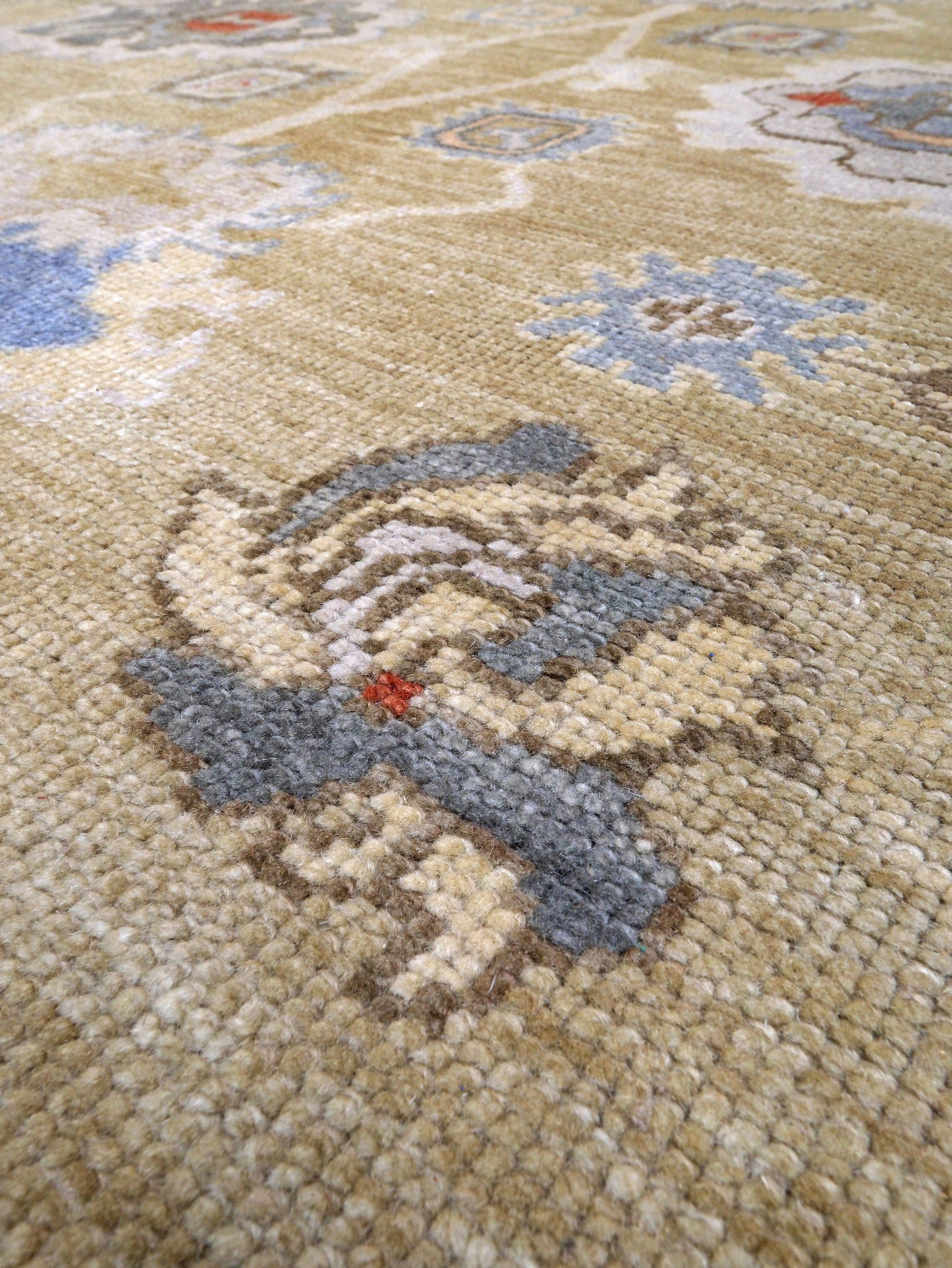 Light olive Turkish Oushak rug with warm ivory border, powder blue floral motifs, soft gray, taupe, and rust accents, hand-knotted wool 10x14 area rug from Indigo Rugs Burlingame Bay Area.