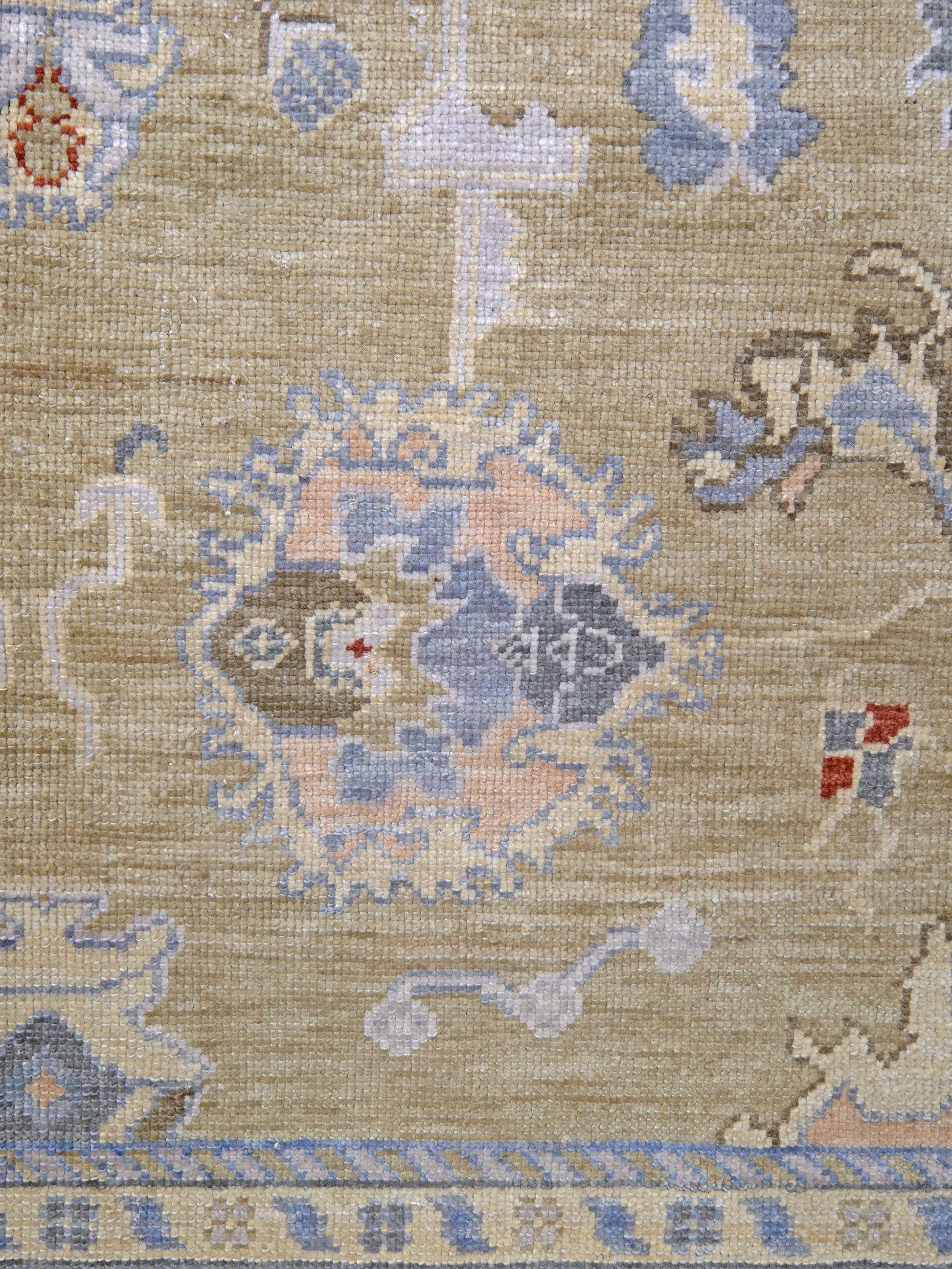 Light olive Turkish Oushak rug with warm ivory border, powder blue floral motifs, soft gray, taupe, and rust accents, hand-knotted wool 10x14 area rug from Indigo Rugs Burlingame Bay Area.